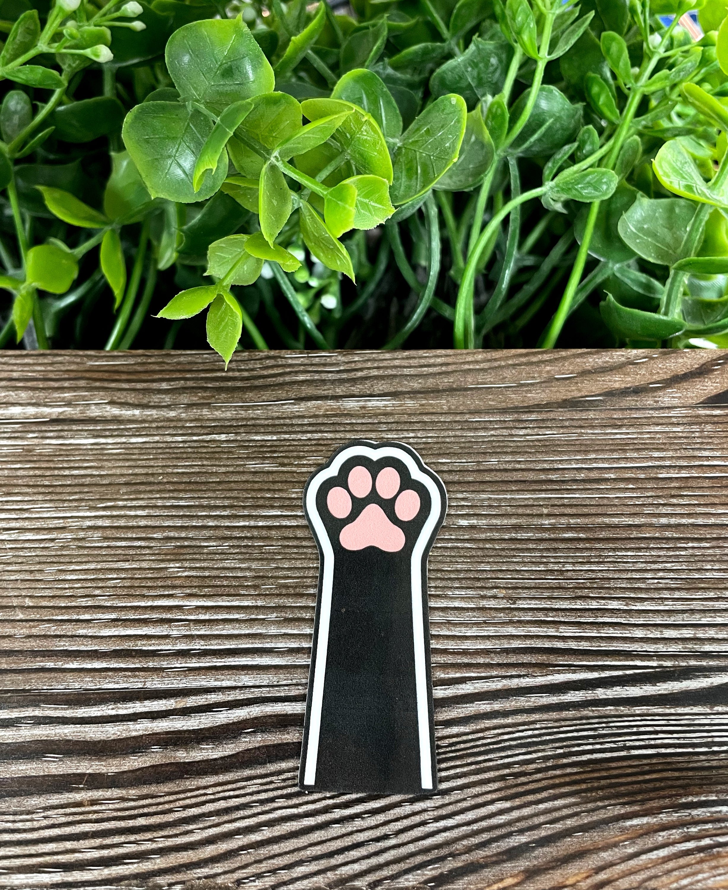 Black Cat Paw Sticker on a smooth surface, showcasing its vibrant design and quality finish.