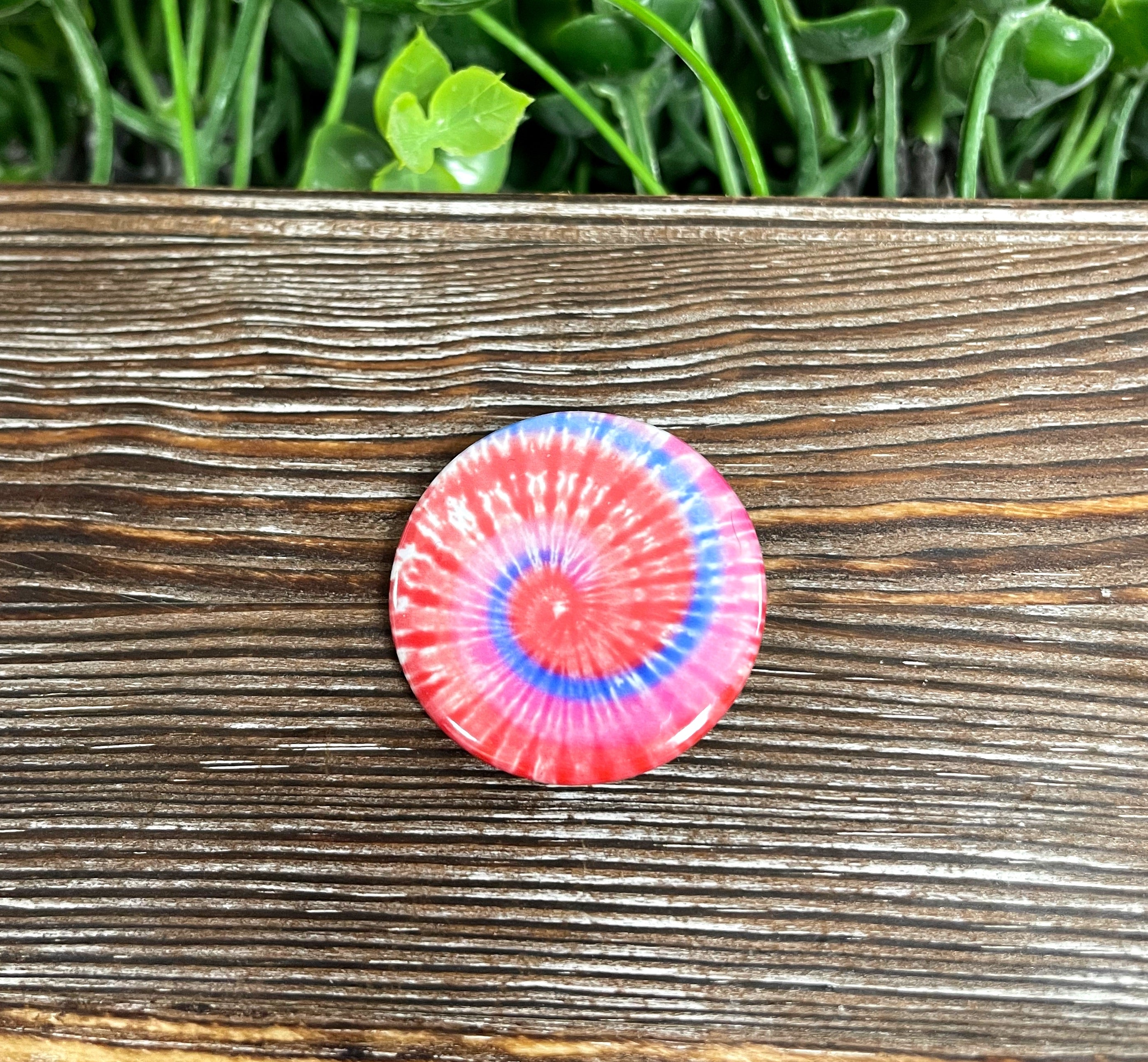 A vibrant Blue Red Tie Dye Swirl Graphic Art Button measuring 1.25 inches, showcasing a colorful swirl pattern.