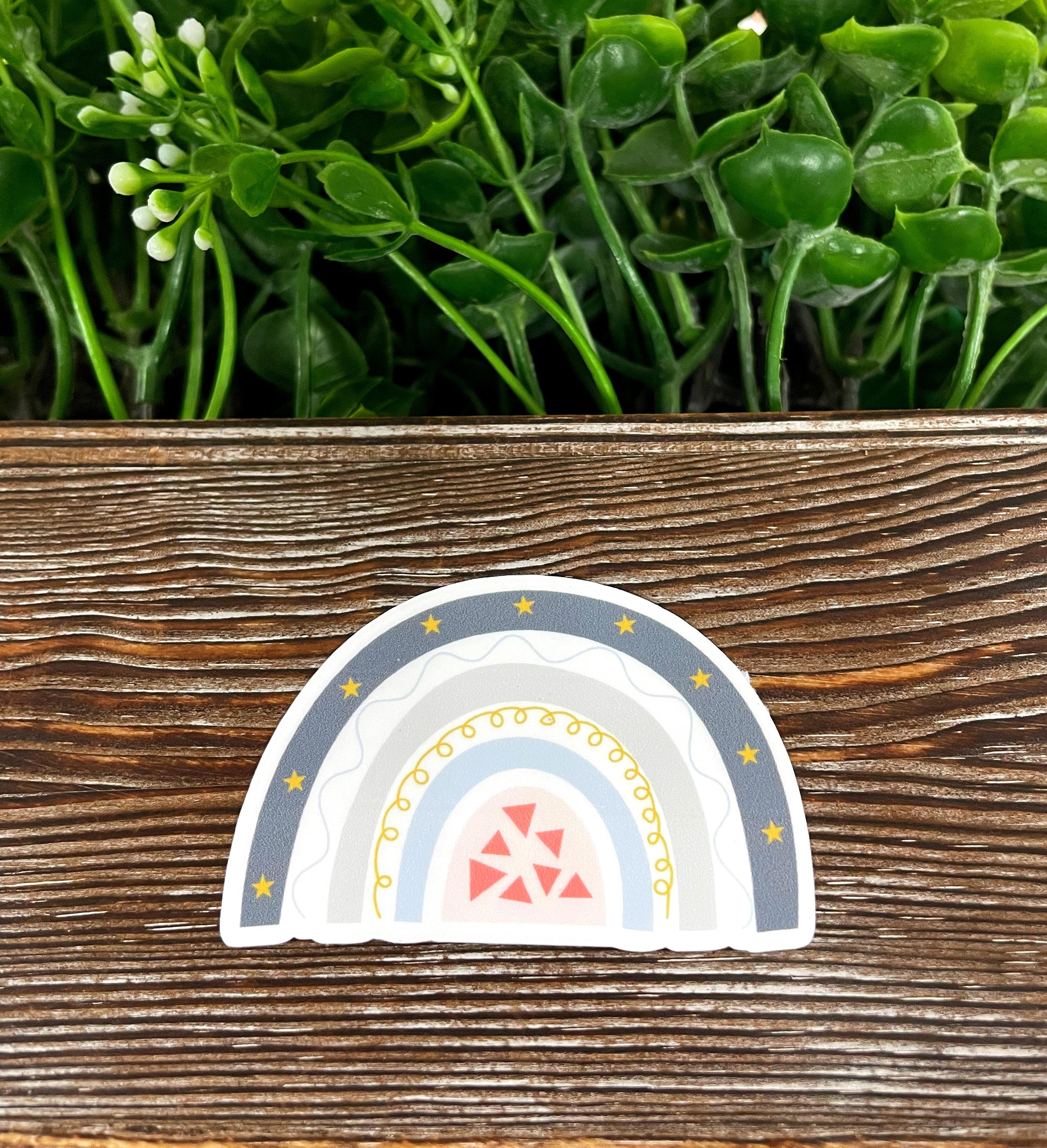 Colorful Bohemian Style Rainbow die cut sticker on a smooth surface, showcasing vibrant colors and intricate design.
