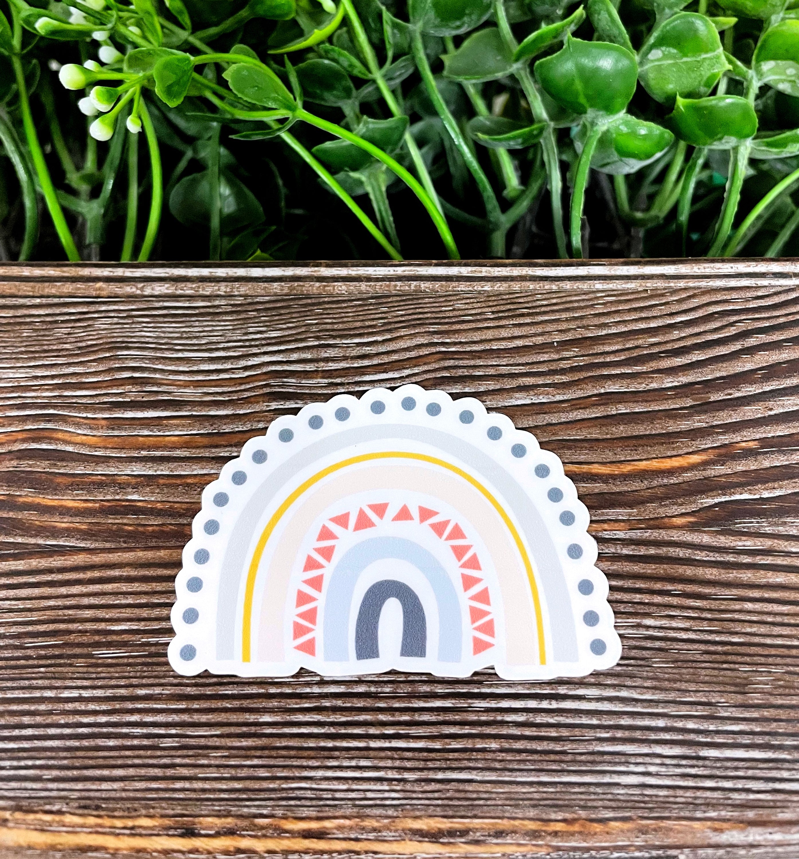 A colorful Boho Rainbow Sticker featuring a vibrant die cut design, perfect for personalizing various smooth surfaces.