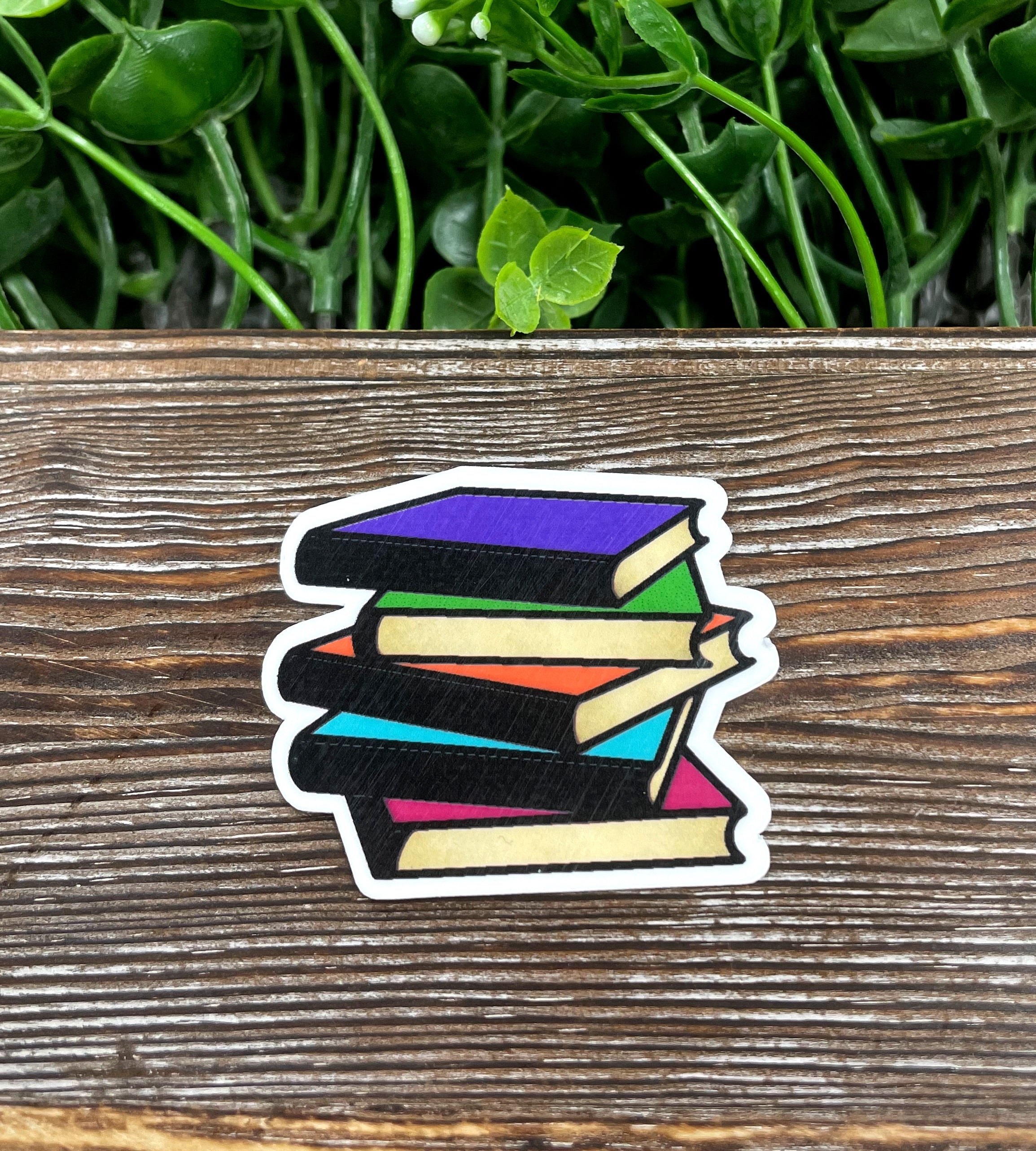 Colorful die cut sticker featuring a stack of books, perfect for book lovers and personalizing items.