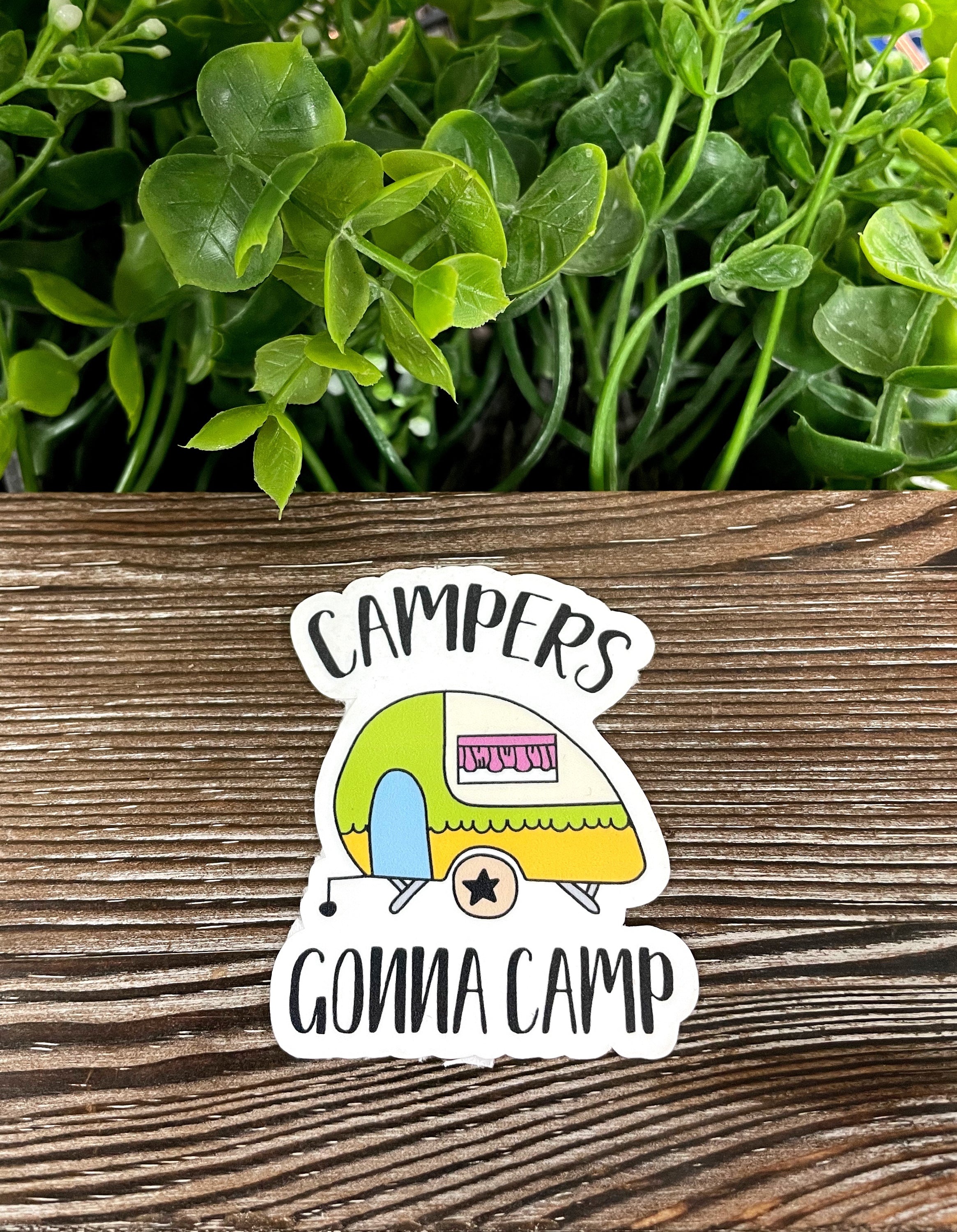 Colorful Campers Gonna Camp die cut vinyl sticker on a smooth surface, showcasing boho design and water-resistant features.