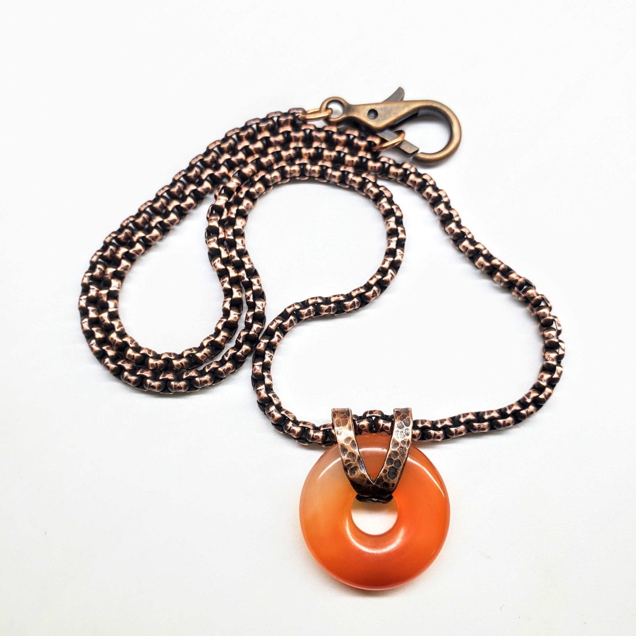 Handcrafted Carnelian Gemstone Donut Necklace with hammered copper pendant and Venezianer box chain, showcasing rustic charm.
