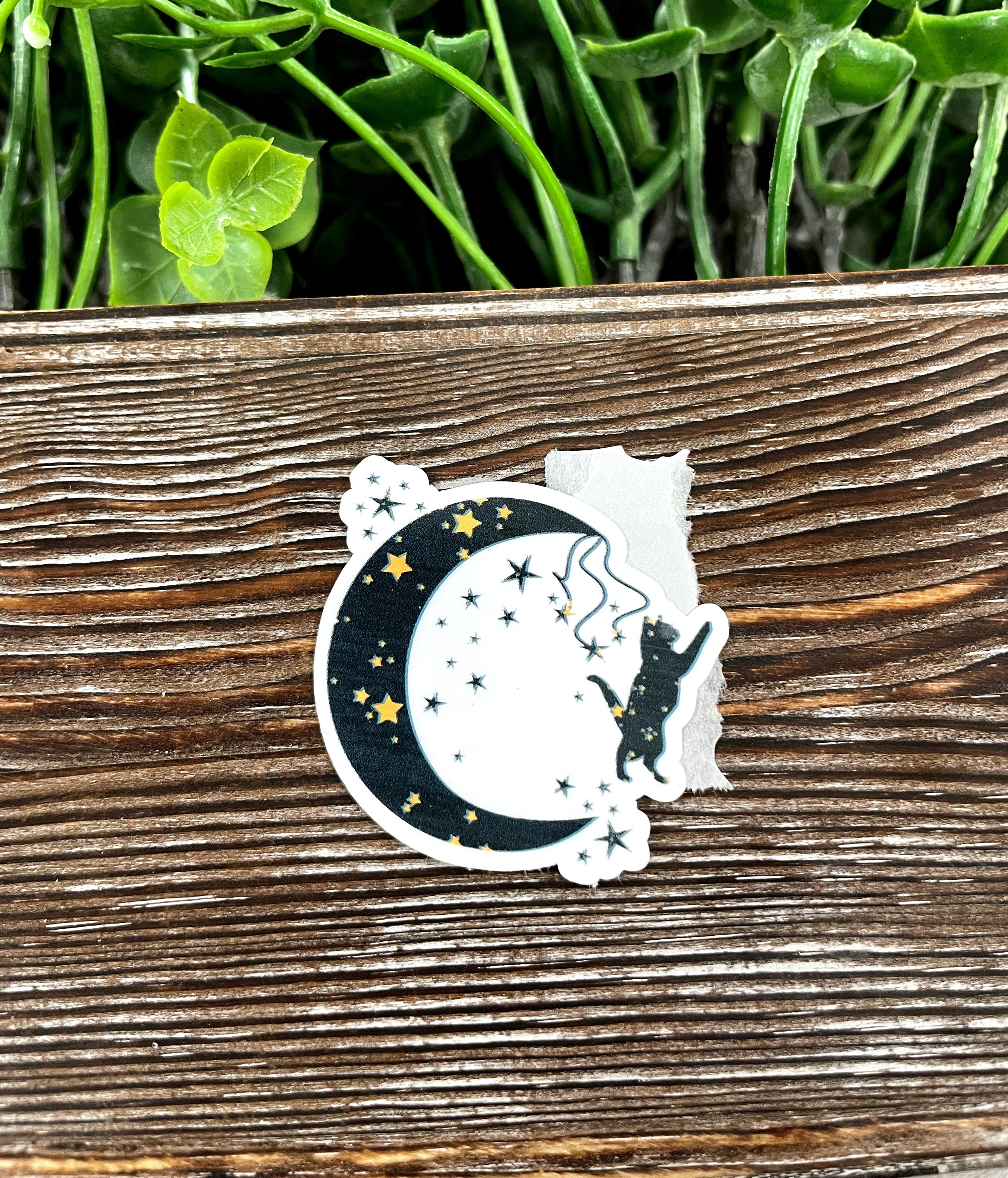 A vibrant Cat and Crescent Moon sticker featuring a whimsical cat silhouette against a crescent moon, perfect for personalizing items.
