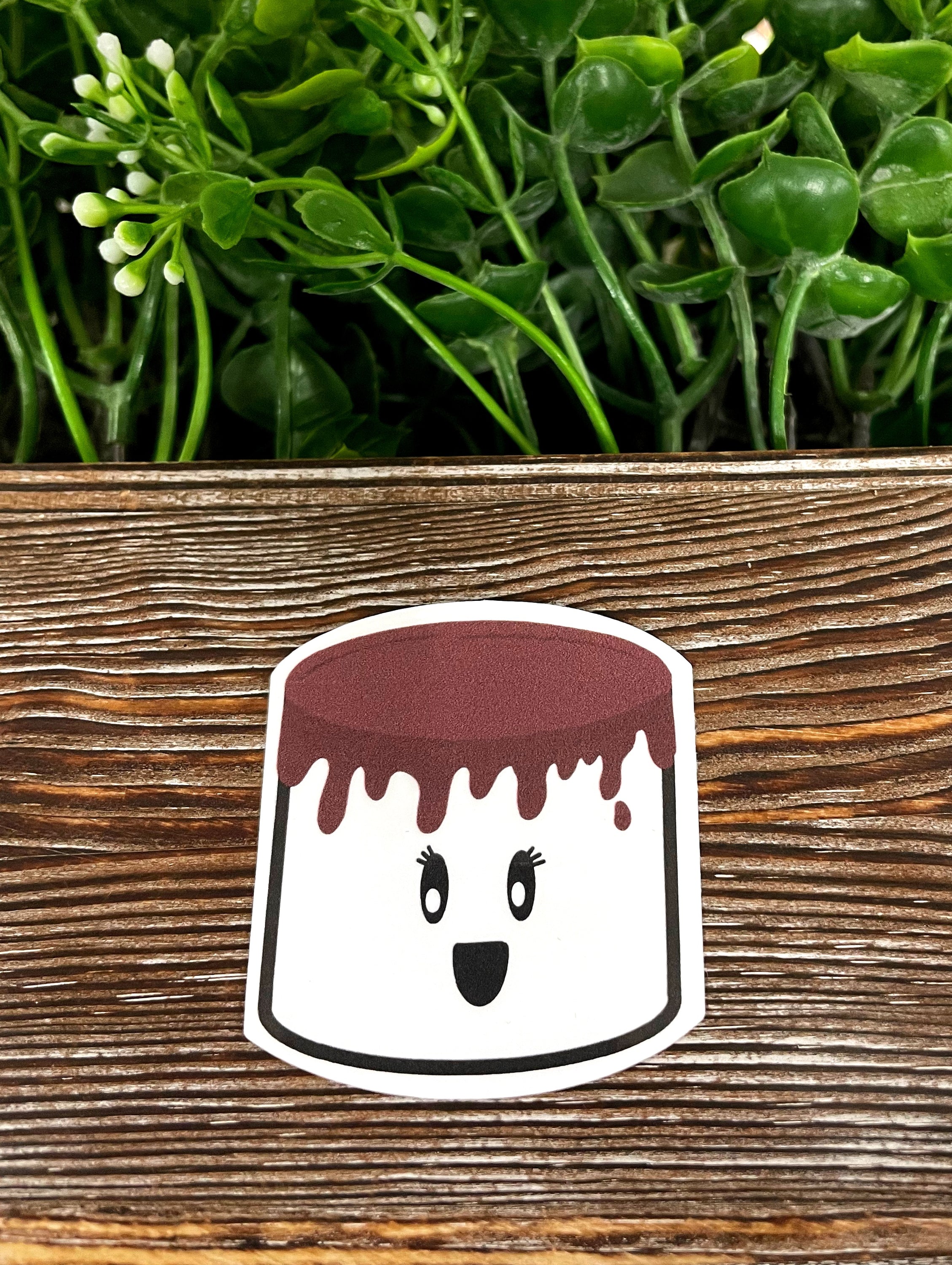 Chocolate Covered Marshmallow die cut sticker on a smooth surface, showcasing vibrant colors and a glossy finish.