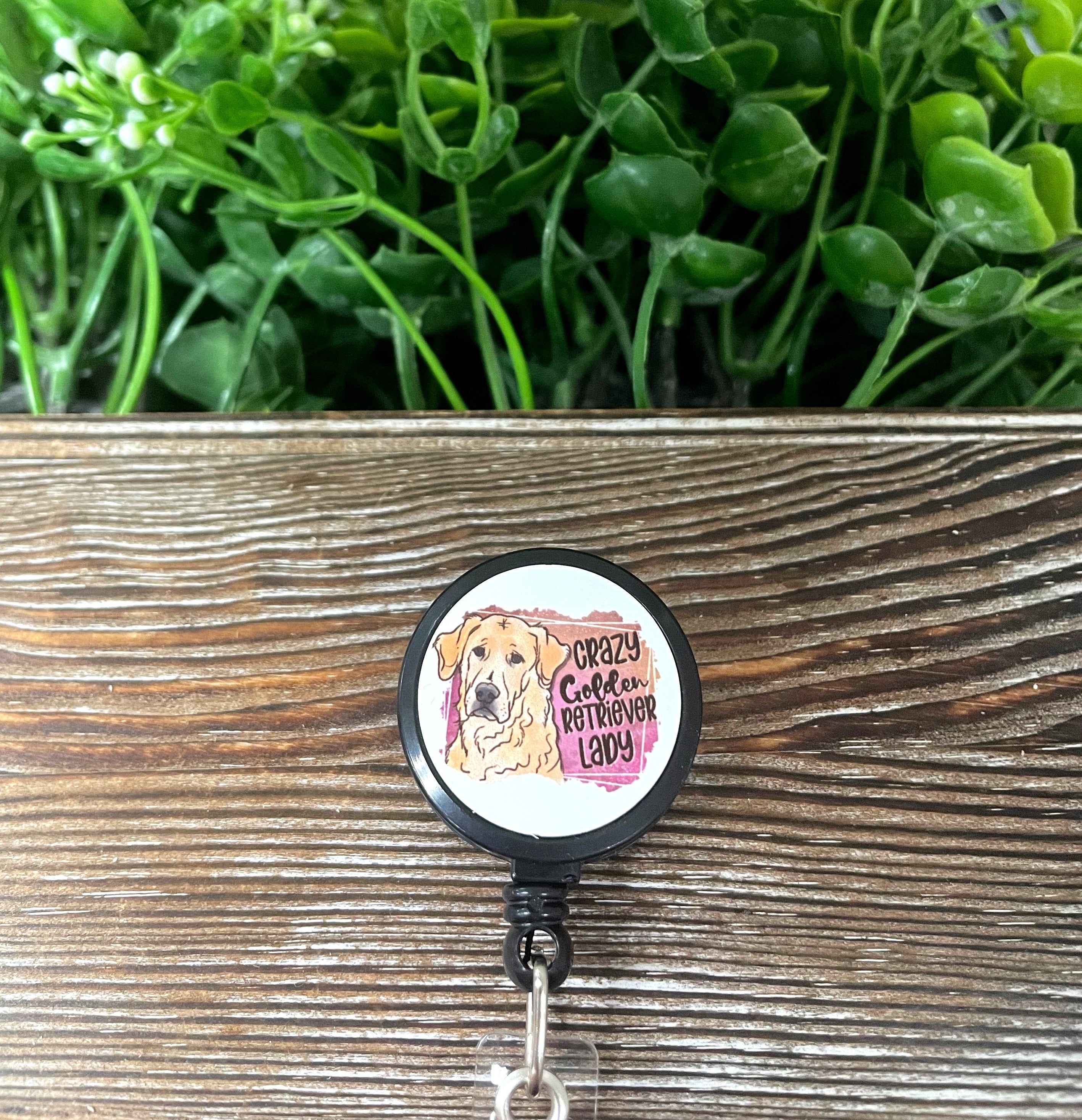 Retractable badge reel featuring a fun Golden Retriever design, made of metal and plastic, measuring 1.2 inches in diameter.