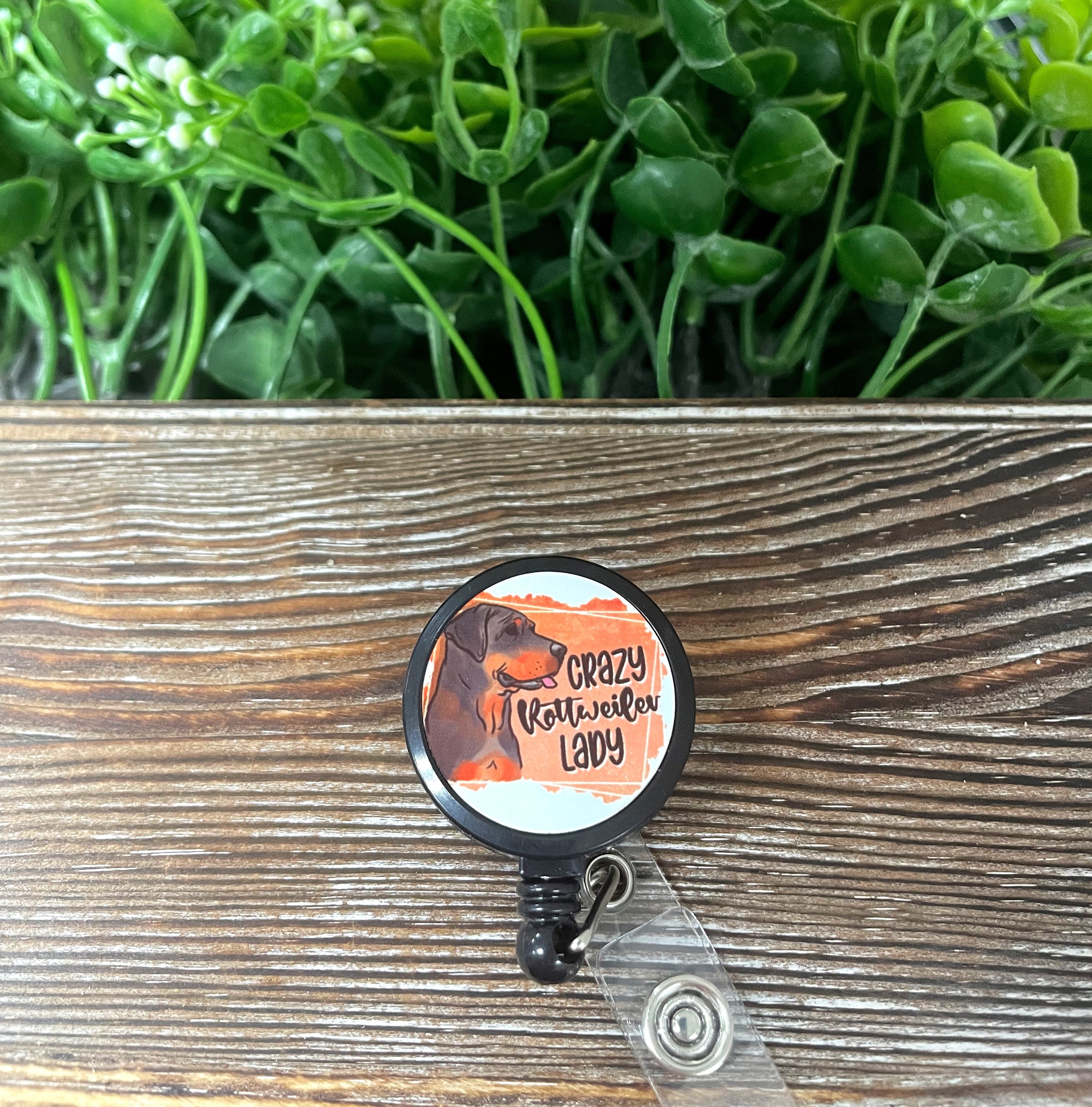 A colorful Crazy Rottweiler Lady retractable badge reel with a 24-inch cord, showcasing a fun design on a metal blank.