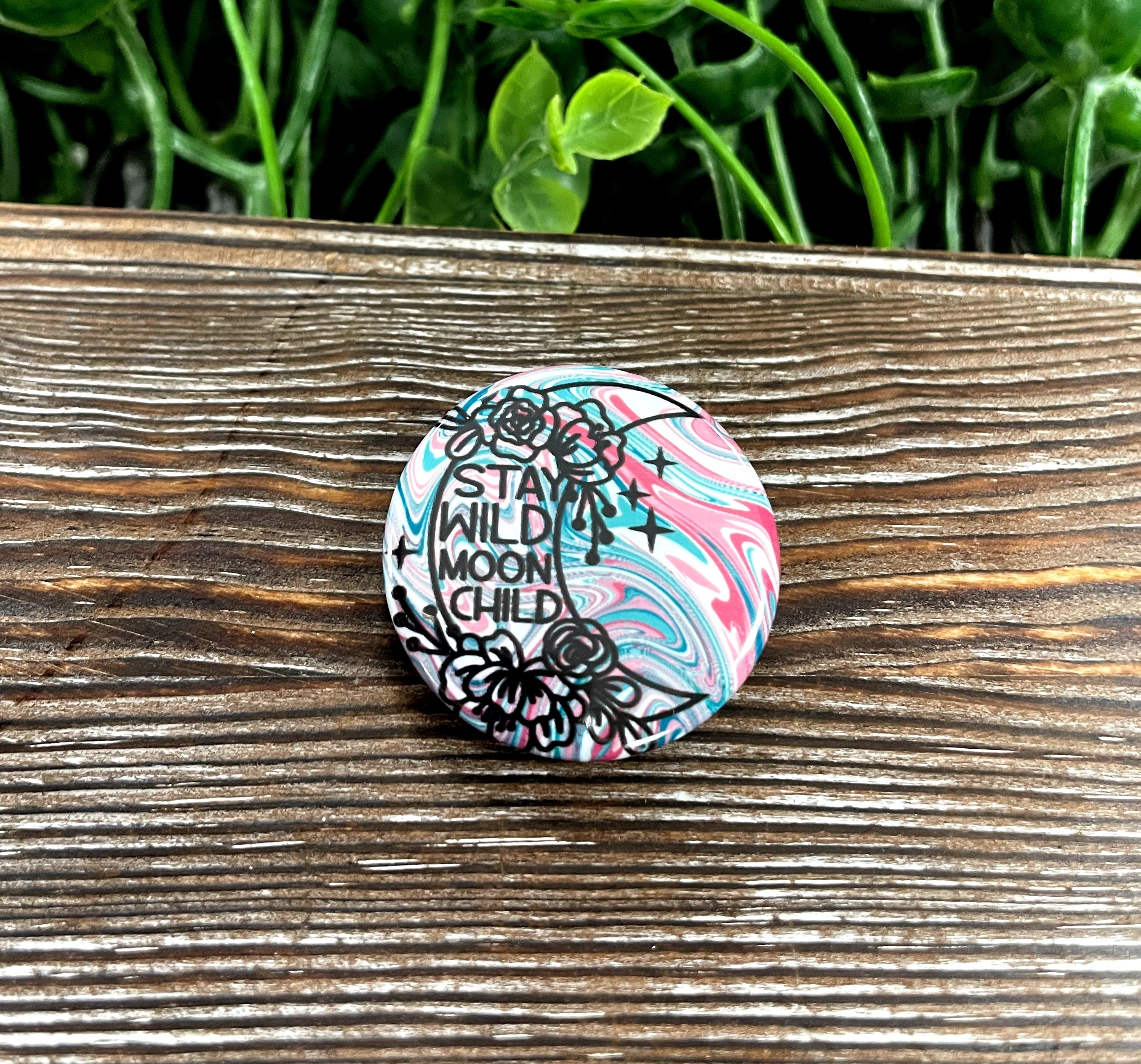 Crescent Moon graphic art button in red and blue, 1.25 inches, featuring a vibrant design.