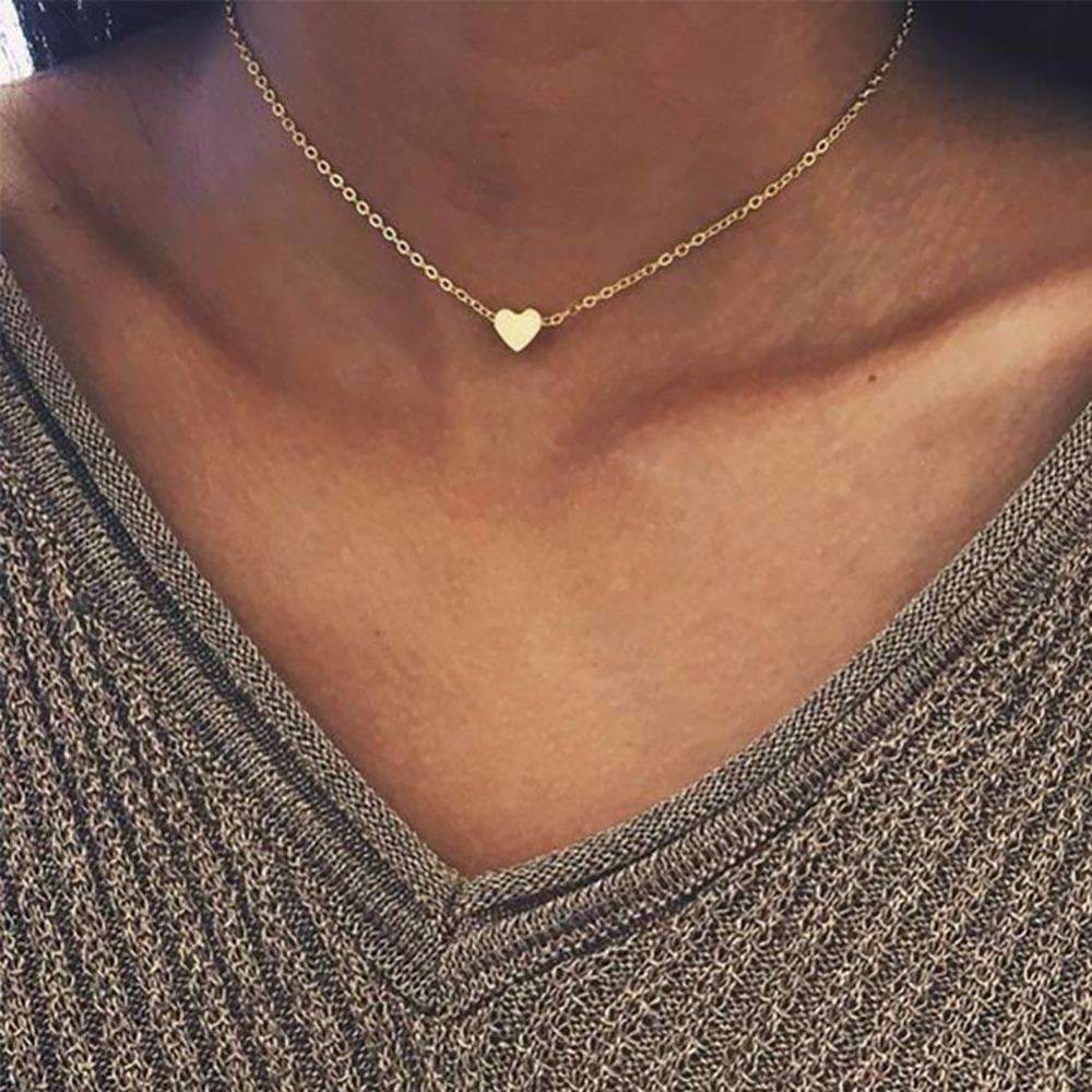 A delicate Dainty Heart Chain necklace featuring a heart pendant, available in silver and gold colors, showcasing its elegant design.