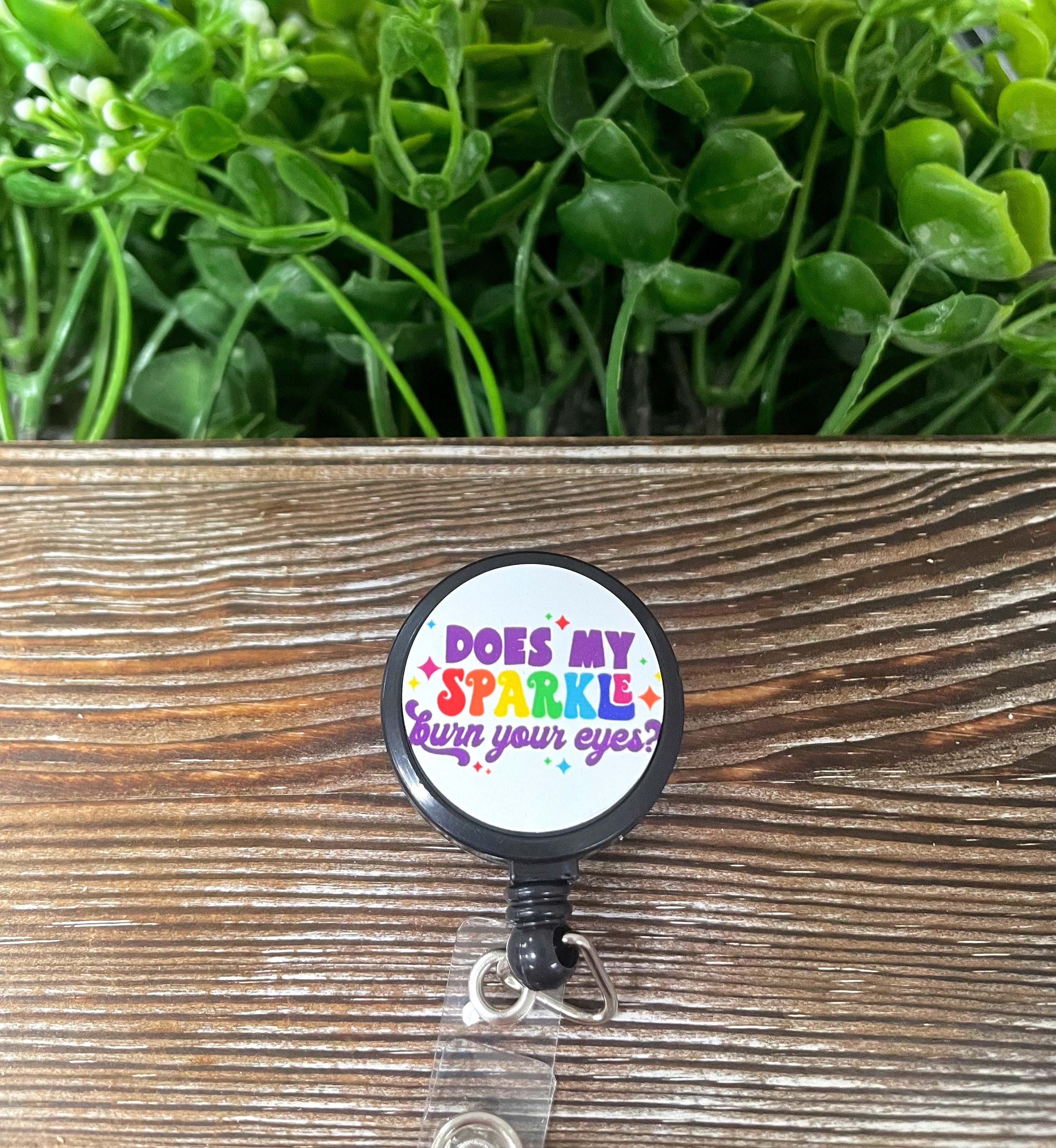 A colorful retractable badge reel featuring a boho design with sparkles, measuring 1.2 inches in diameter and a 24-inch extension cord.