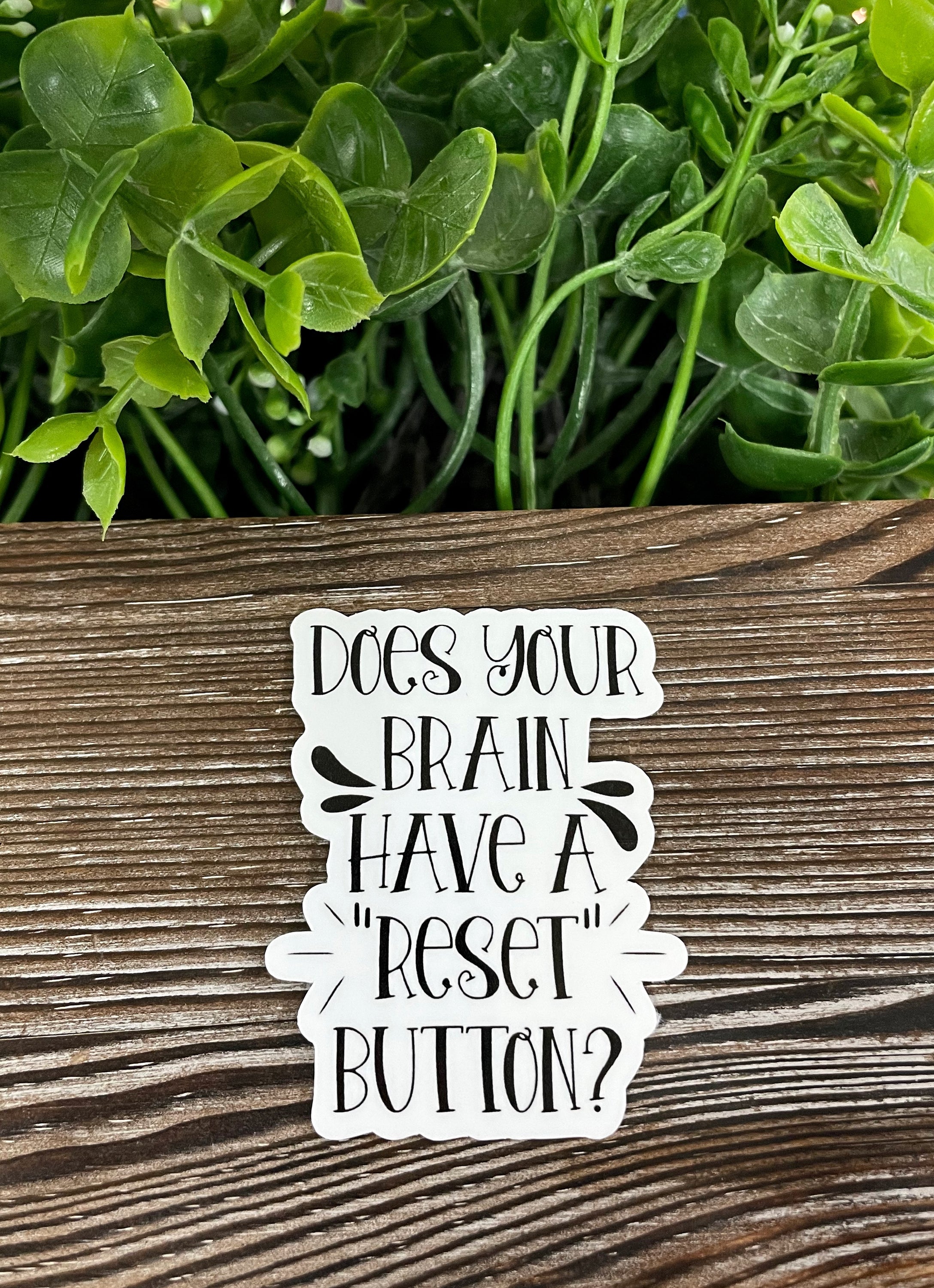 Colorful die cut vinyl sticker featuring the phrase 'Does Your Brain Have a Reset Button', ideal for personalizing smooth surfaces.