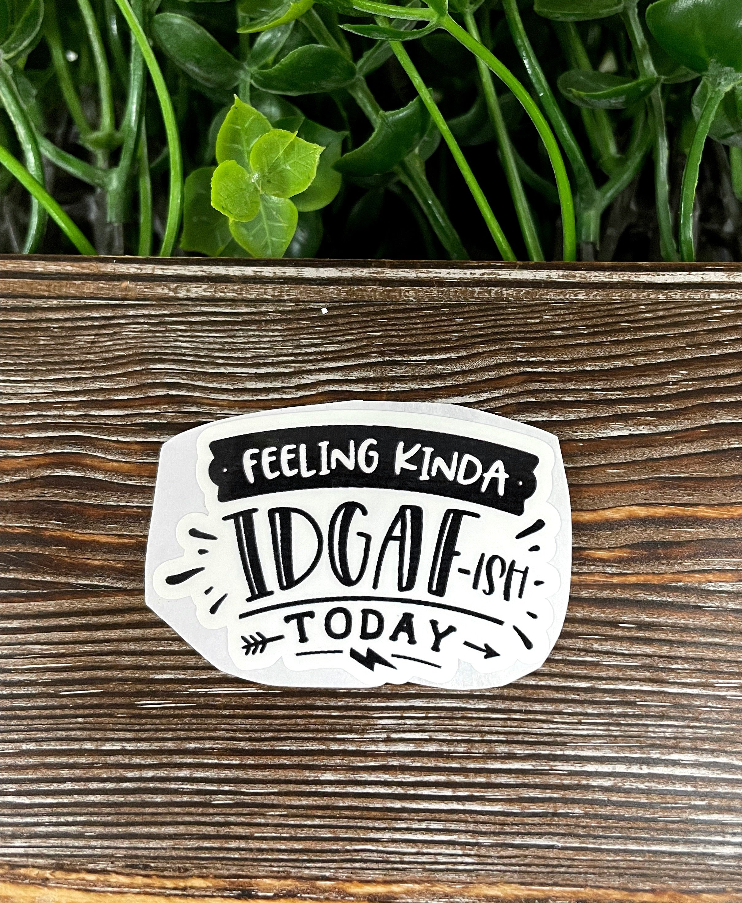 Die cut sticker featuring a snarky IDGAF quote, showcasing vibrant colors and a fun design, perfect for personalizing smooth surfaces.