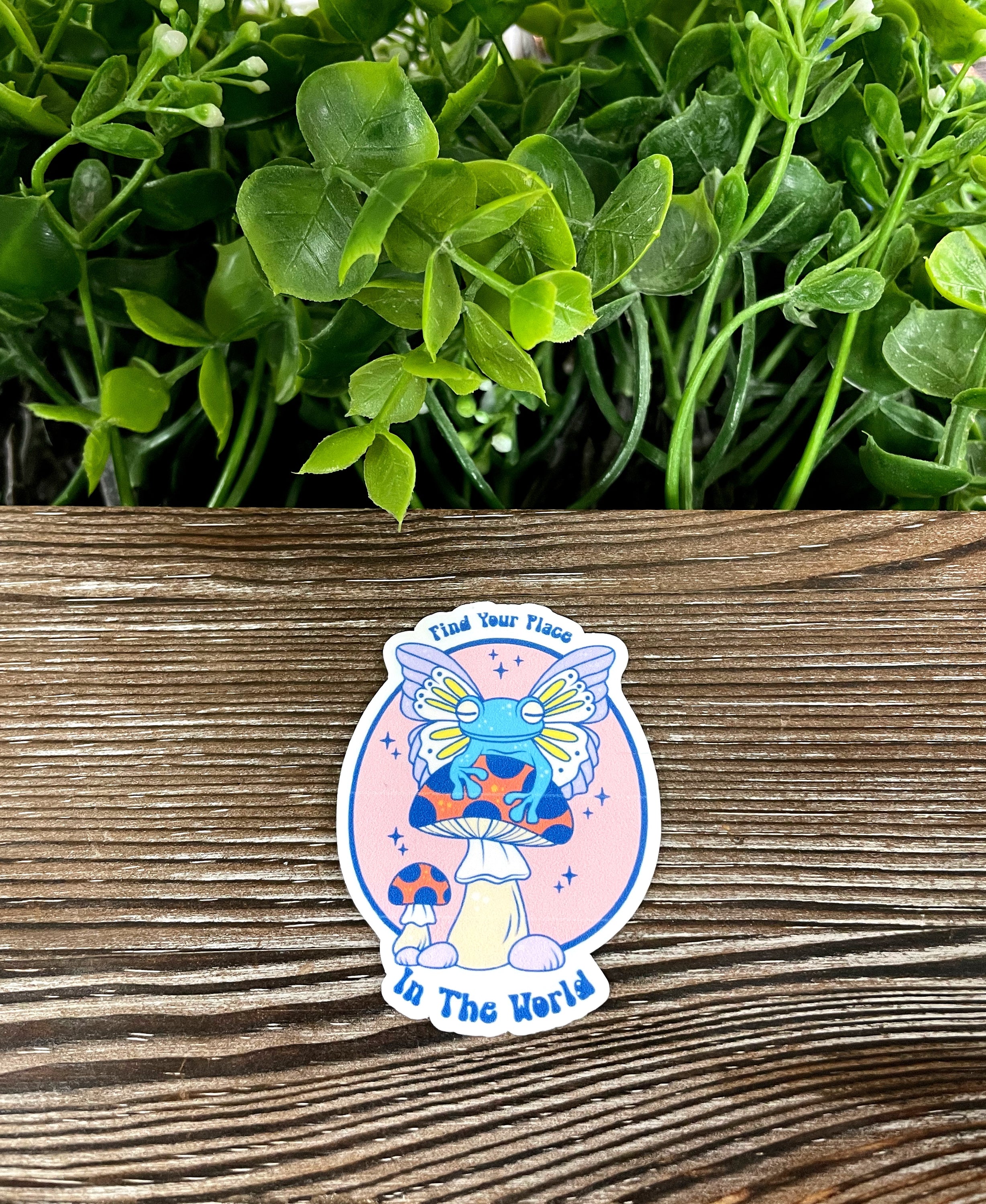 Die cut vinyl sticker featuring a cute frog sitting on a colorful background, ideal for personalizing various items.