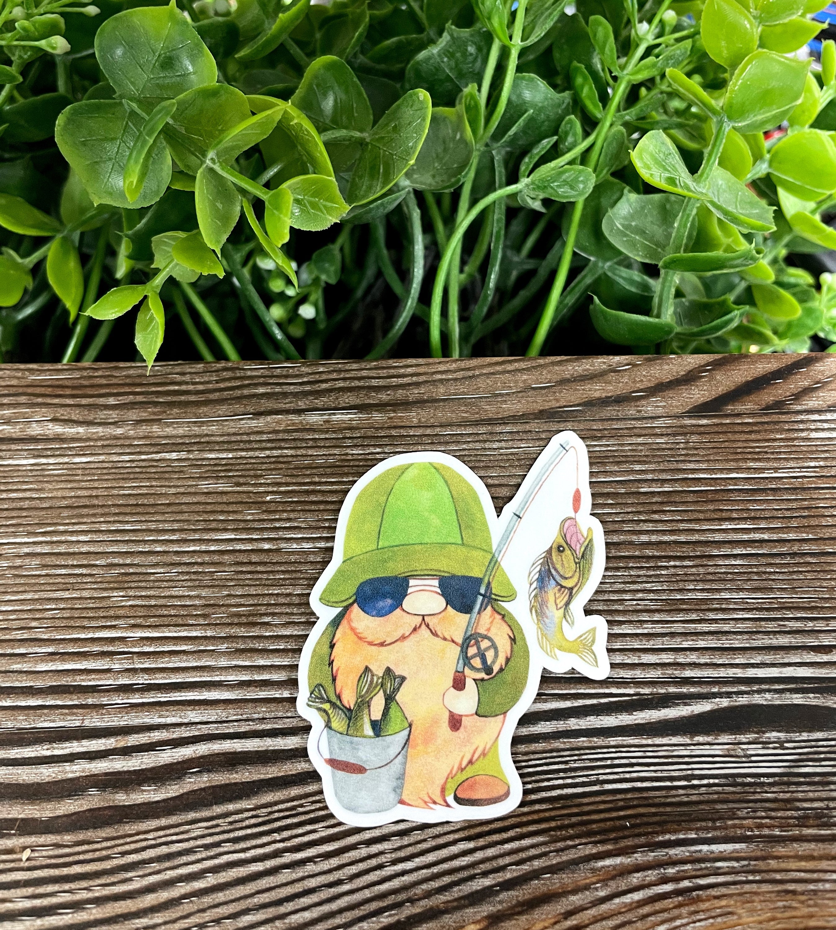 Fisherman gnome die cut vinyl sticker with vibrant colors and whimsical design, perfect for personalizing smooth surfaces.