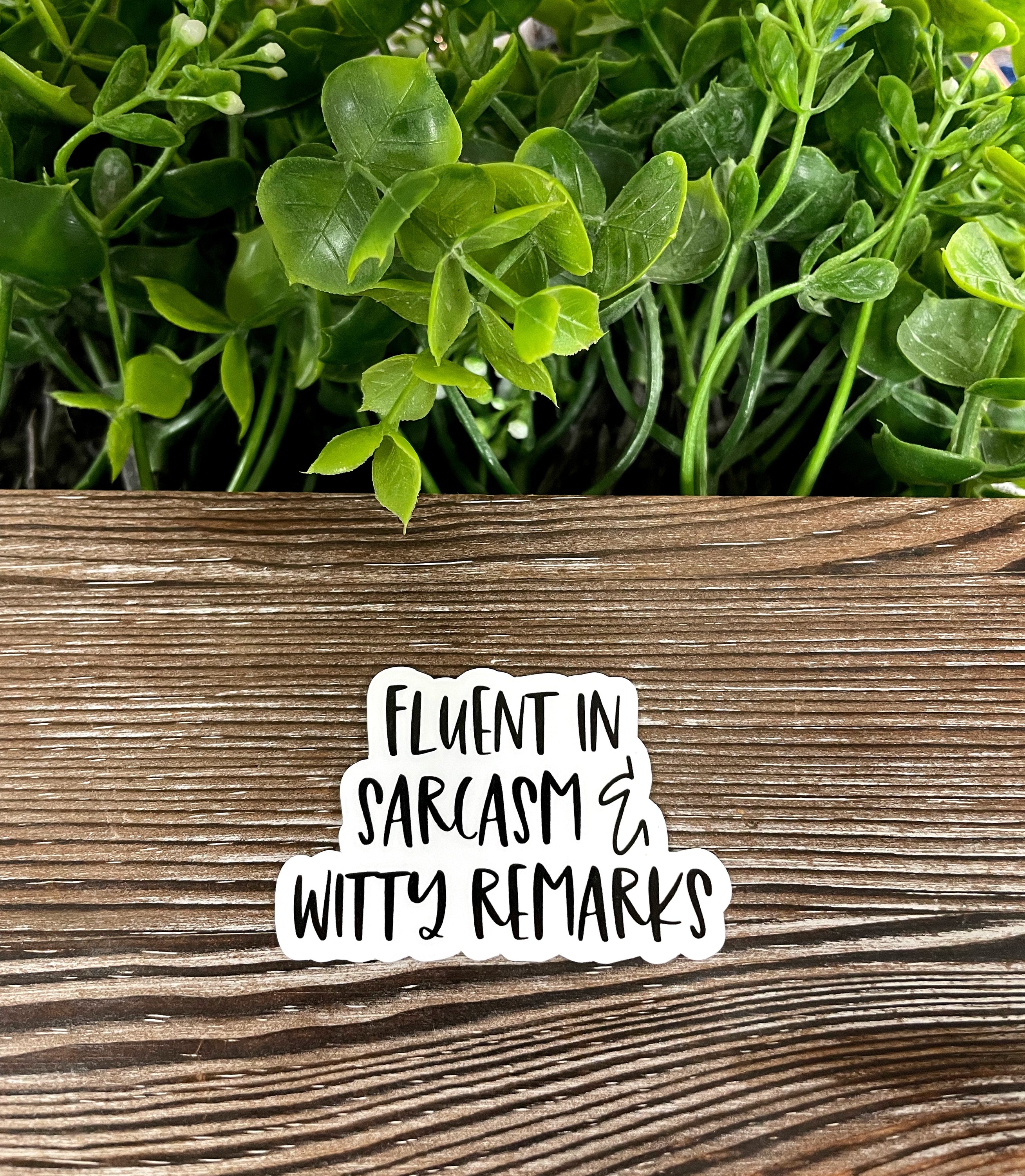 A colorful die cut vinyl sticker featuring the phrase 'Fluent in Sarcasm and Witty Remarks', showcasing a fun and boho design.