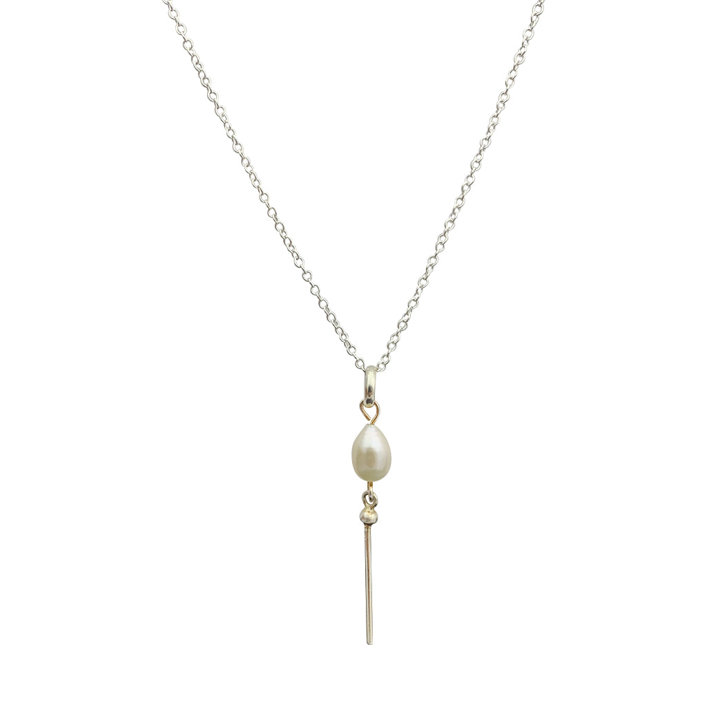 A delicate Freshwater Pearl Bar Necklace featuring a sterling silver chain and a bar of lustrous freshwater pearls, handmade in Peru.