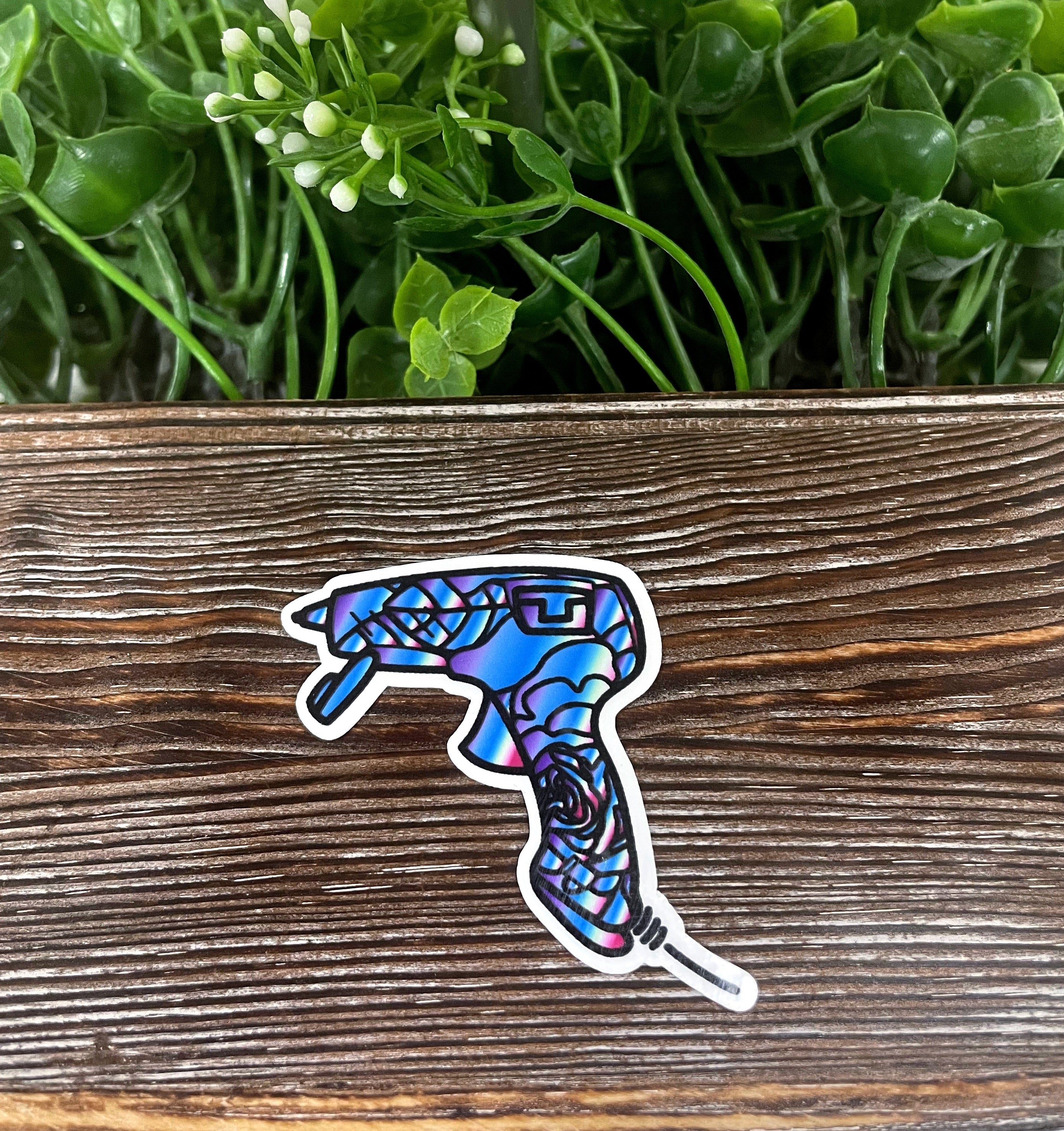 Colorful Glue Gun Sticker on a smooth surface, showcasing its vibrant design and quality finish.