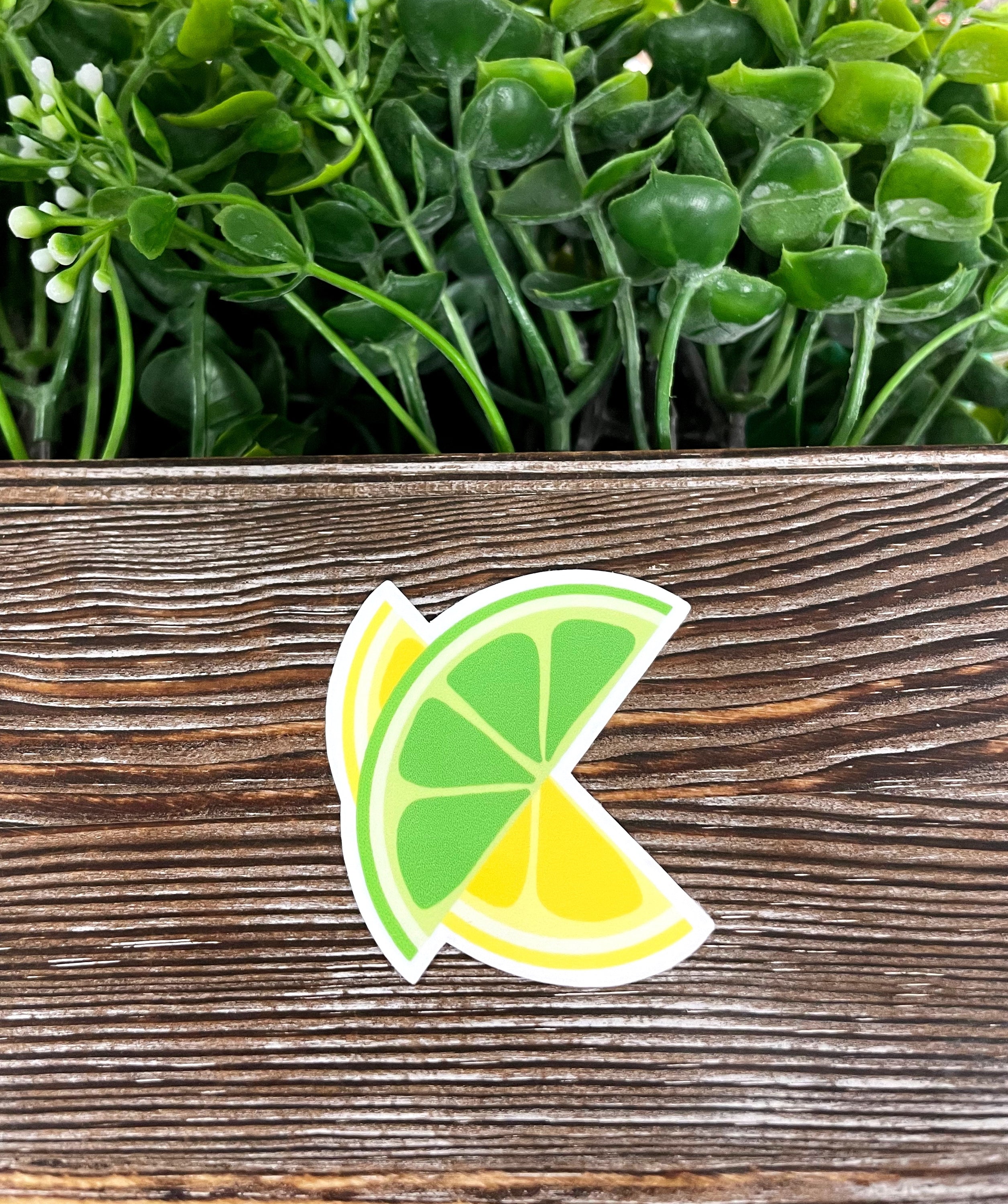 A vibrant die cut sticker featuring a green lime slice and a yellow lemon slice, showcasing bright colors and intricate details.