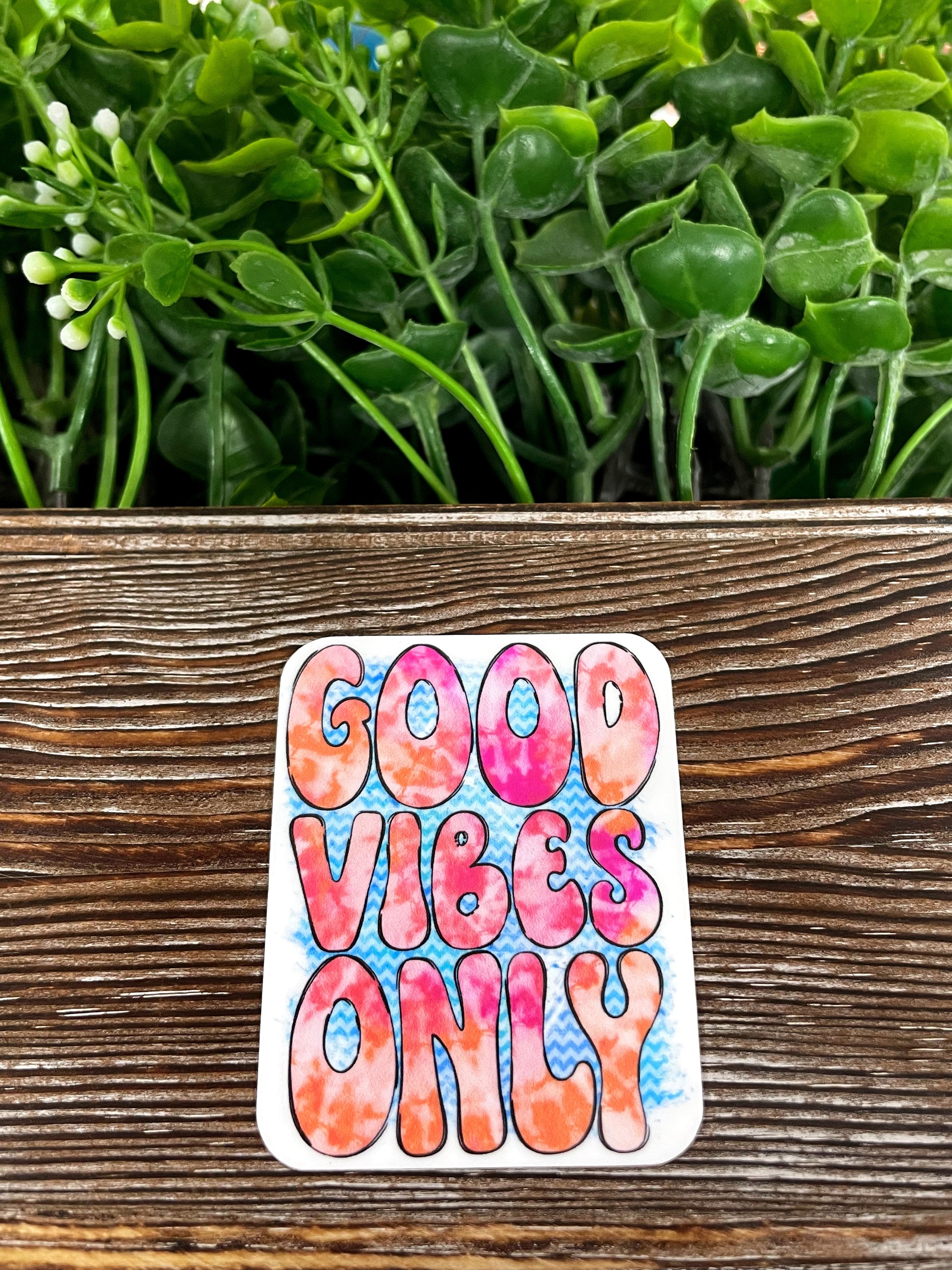 Groovy Good Vibes Only die cut sticker on a smooth surface, showcasing vibrant colors and a fun design.