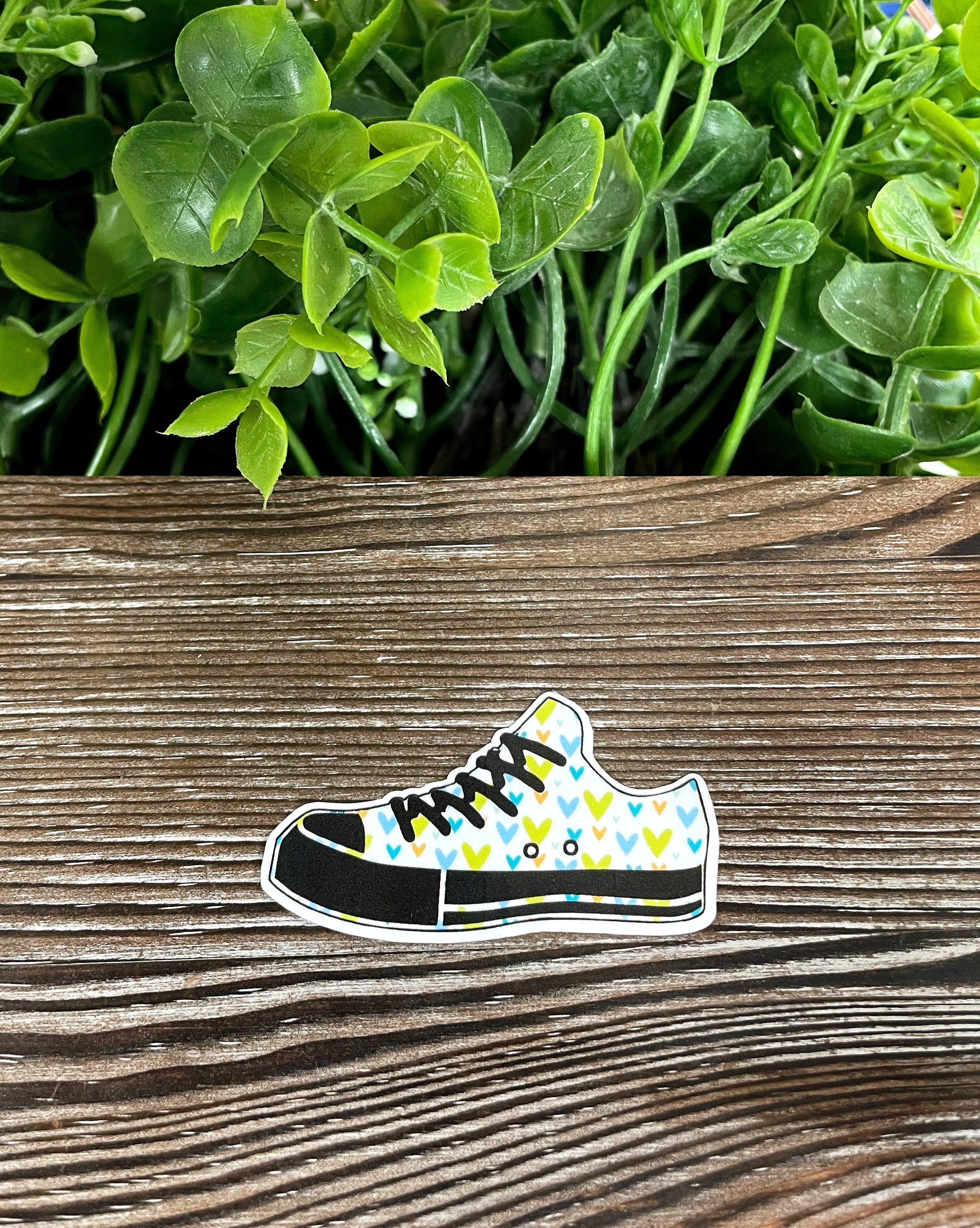 Colorful Hearts Low Top Shoes Sticker on a smooth surface, showcasing its vibrant design and quality finish.