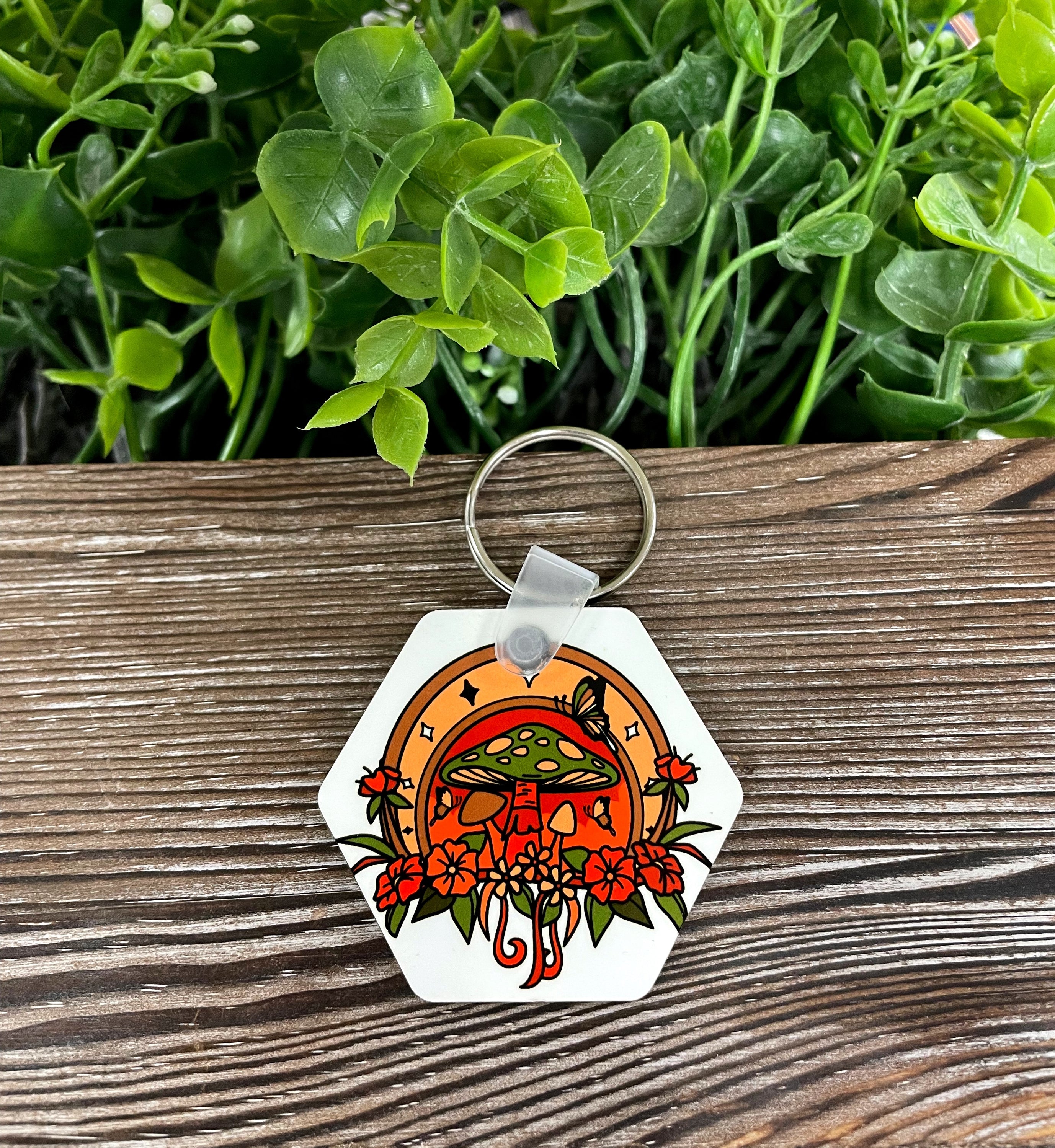 A lightweight MDF hexagon keychain featuring a whimsical horseshoe mushroom design, perfect for boho style enthusiasts.