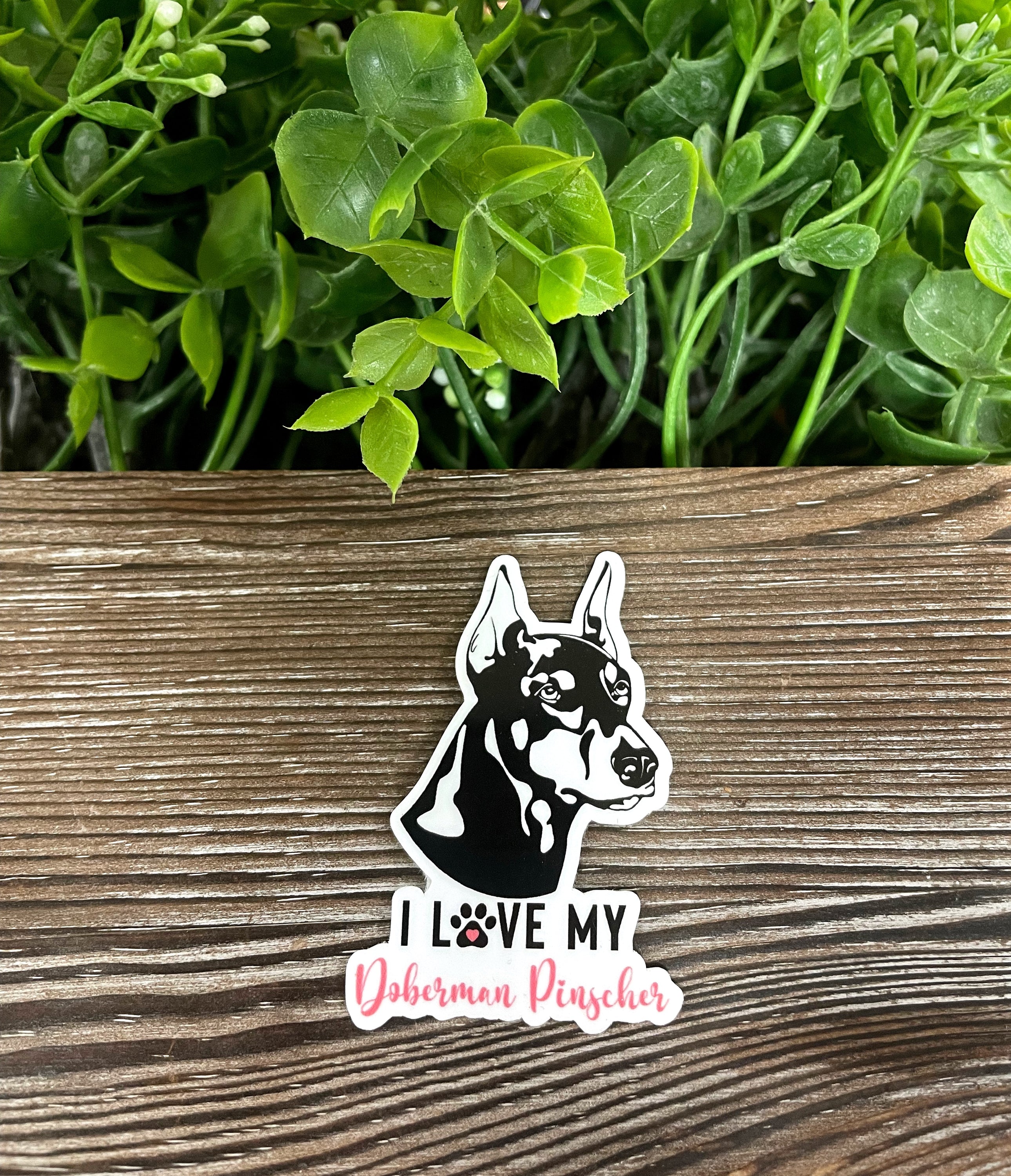 A vibrant 'I Love my Doberman Pinscher' sticker featuring a die-cut design, showcasing a Doberman silhouette and colorful text.