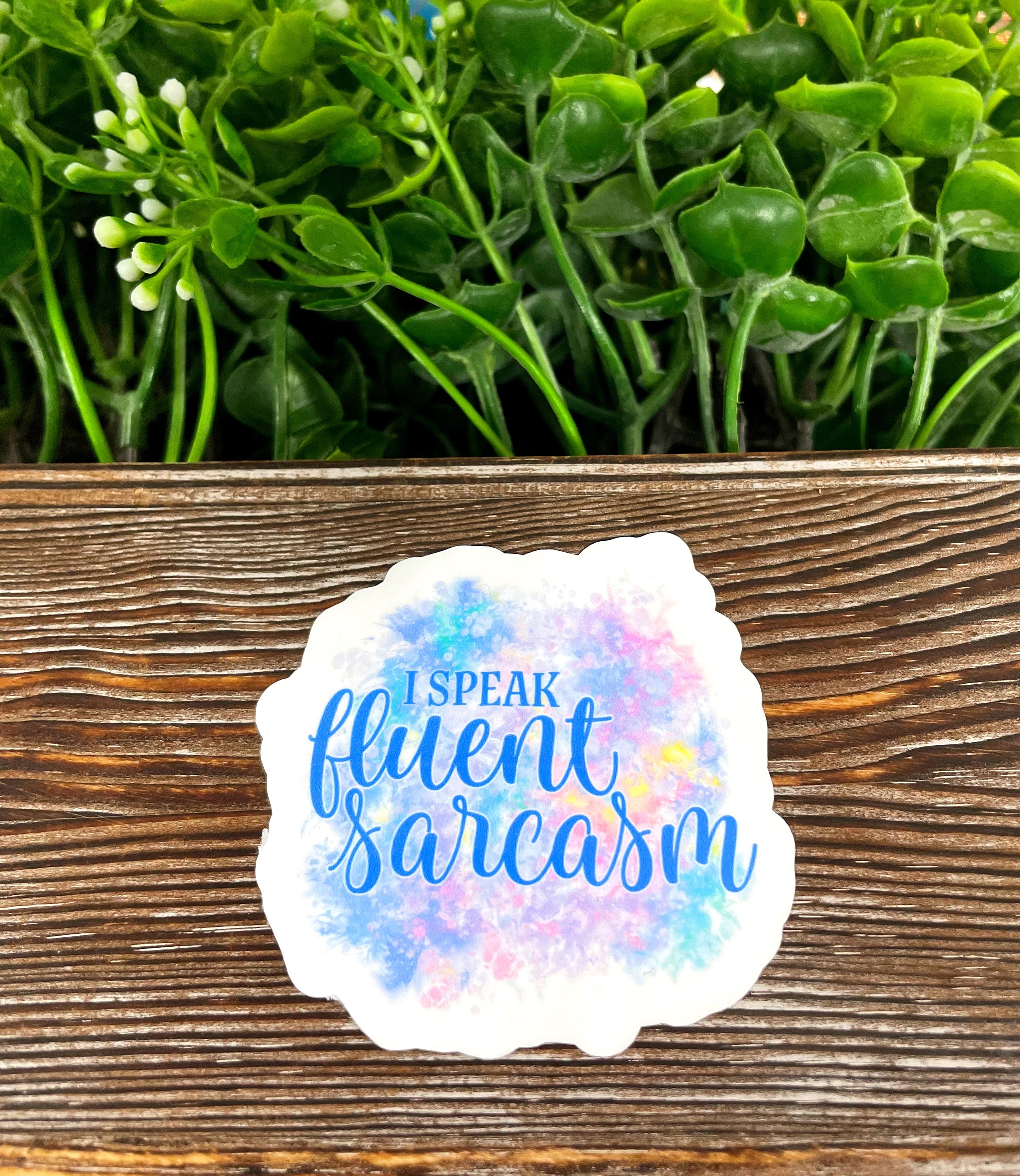 I Speak Fluent Sarcasm die cut sticker on a smooth surface, showcasing vibrant colors and a humorous design.