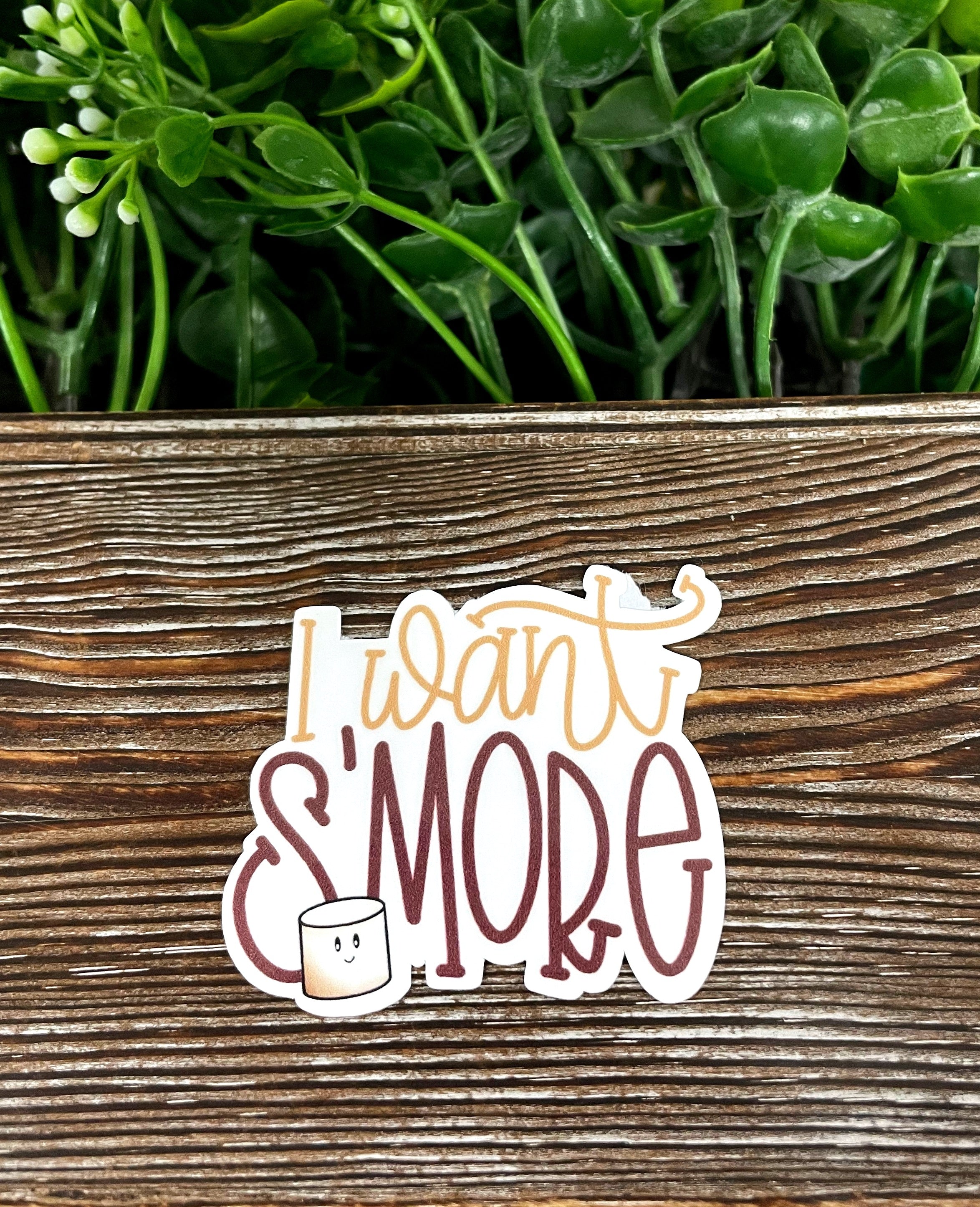 I Want S'more die cut sticker featuring a fun camping design, made from high-quality vinyl with a water-resistant laminate finish.