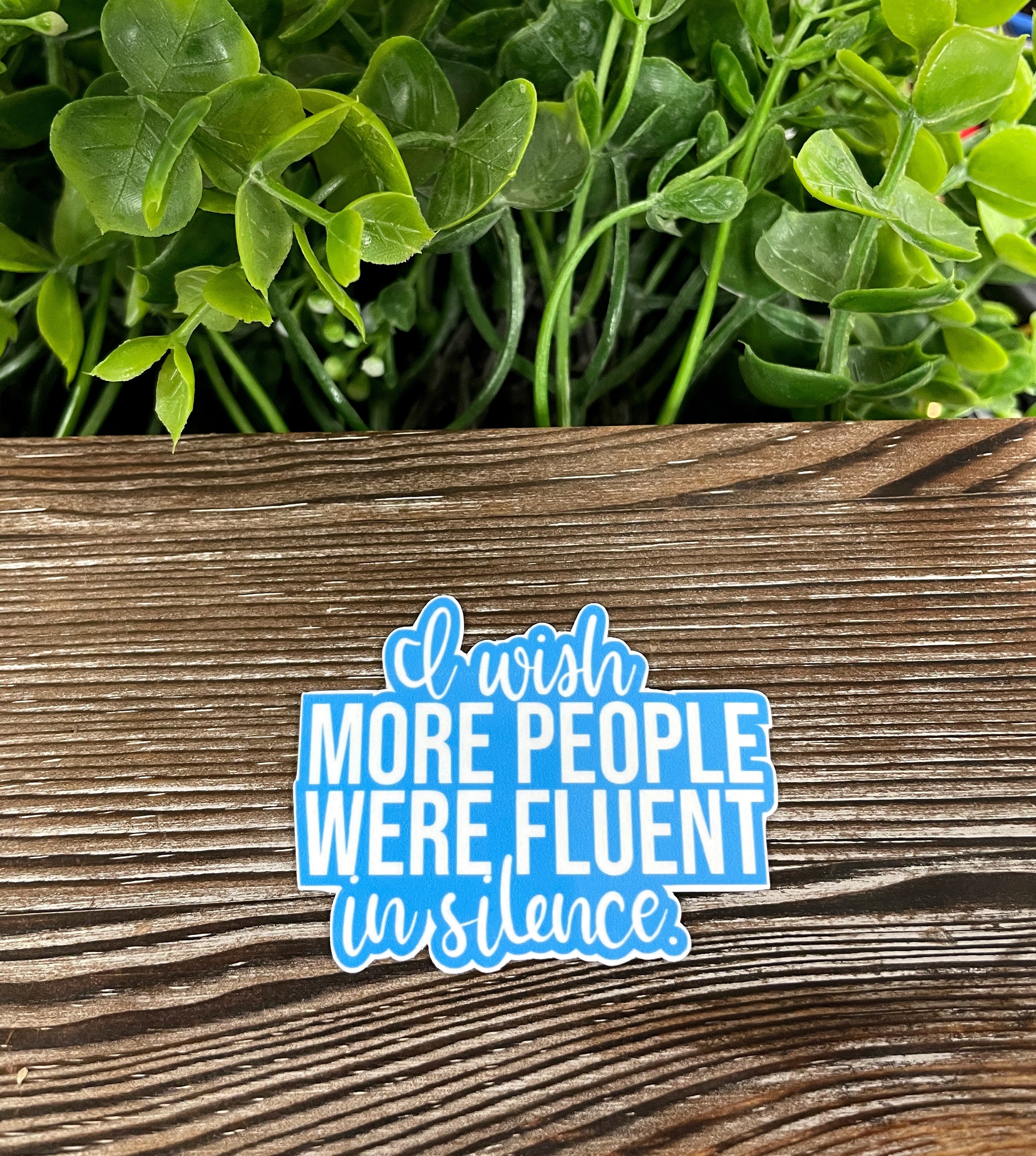 I Wish More People were Fluent in Silence die cut vinyl sticker on a smooth surface, showcasing its boho design and vibrant colors.