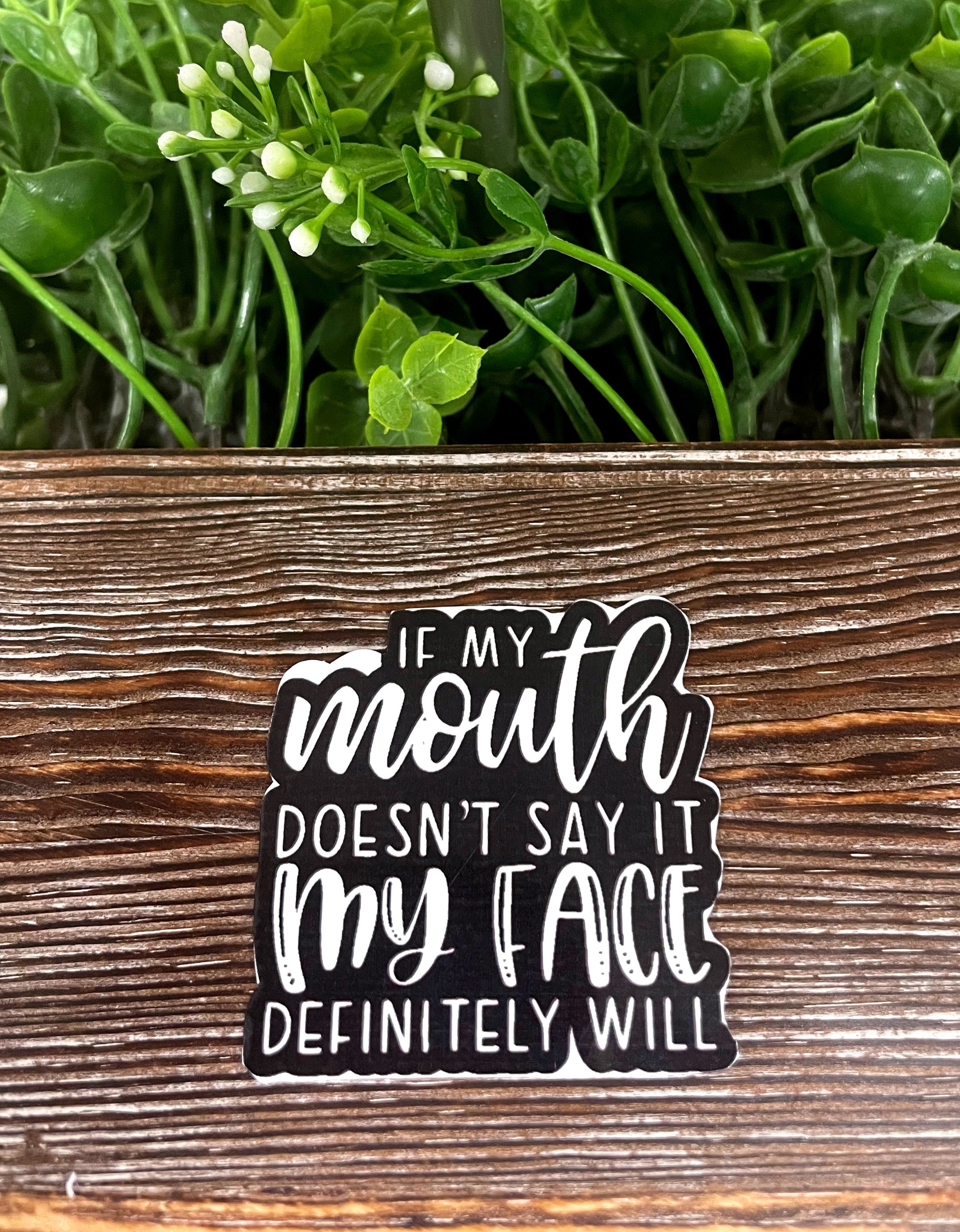 If My Mouth Doesn't Say it My Face Definitely Will vinyl sticker on a smooth surface, showcasing vibrant colors and a humorous design.