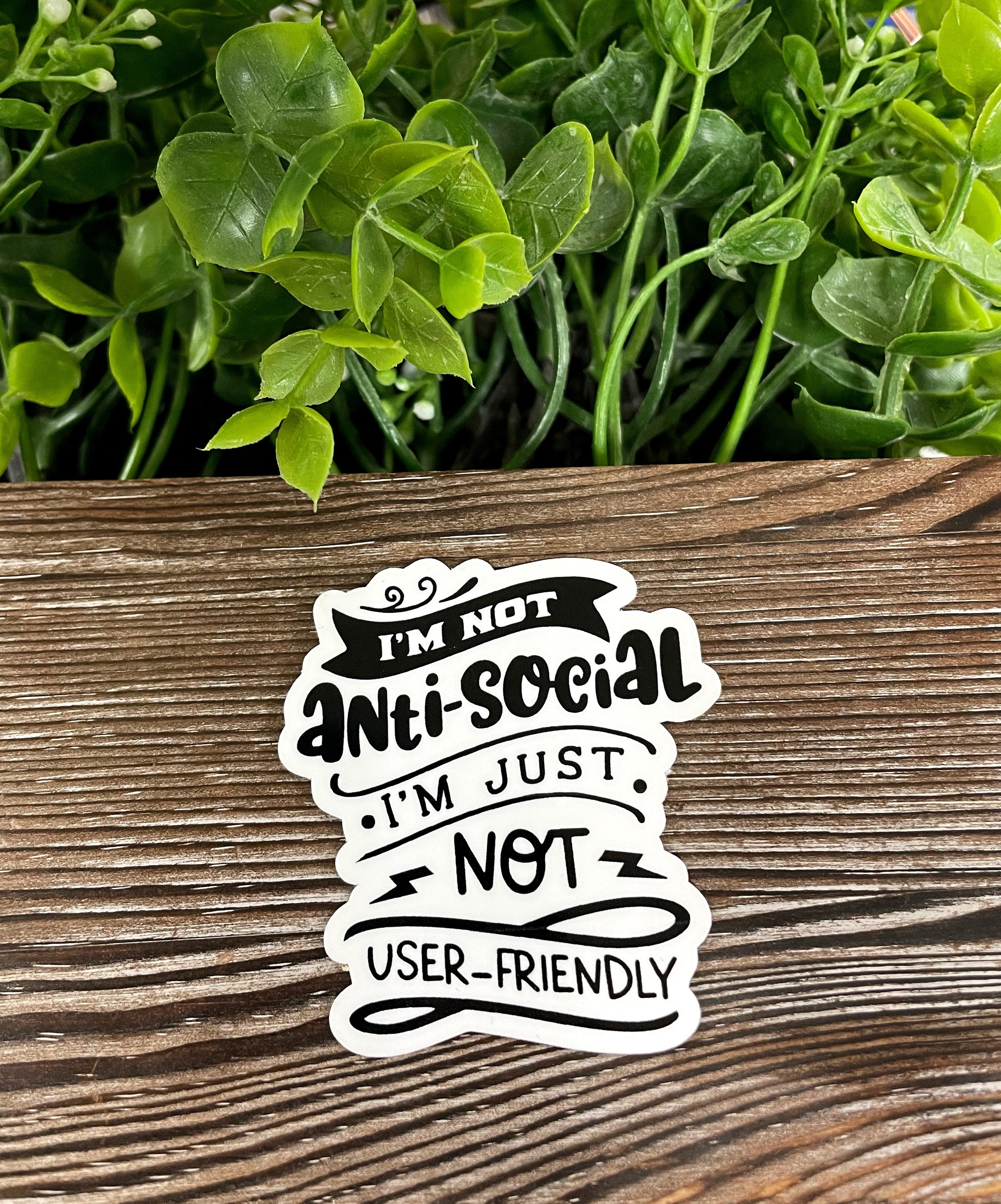 Die cut sticker with the phrase 'I'm not Antisocial I'm Just Not User Friendly', featuring vibrant colors and a glossy finish.