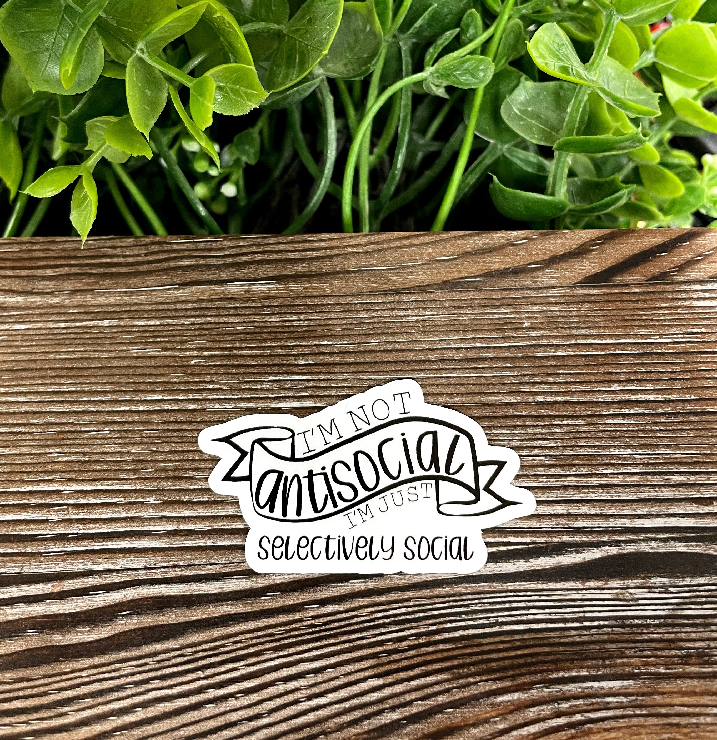 Die cut vinyl sticker with the phrase 'I'm Not Antisocial I'm Just Selectively Social', showcasing a fun and quirky design.