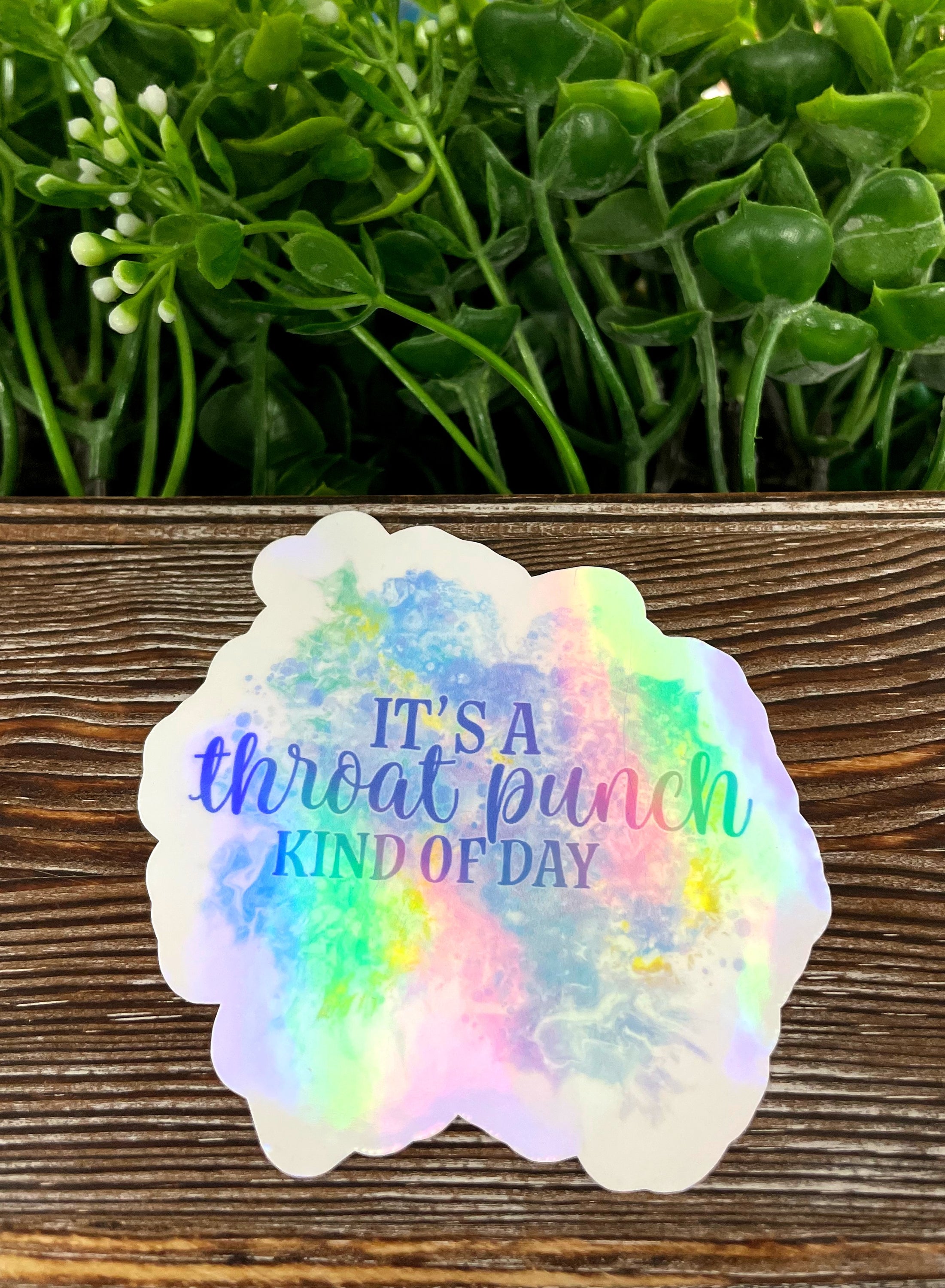 A vibrant die cut vinyl sticker featuring the phrase 'It's a Throat Punch Kind of Day' with a boho design, perfect for personalizing items.
