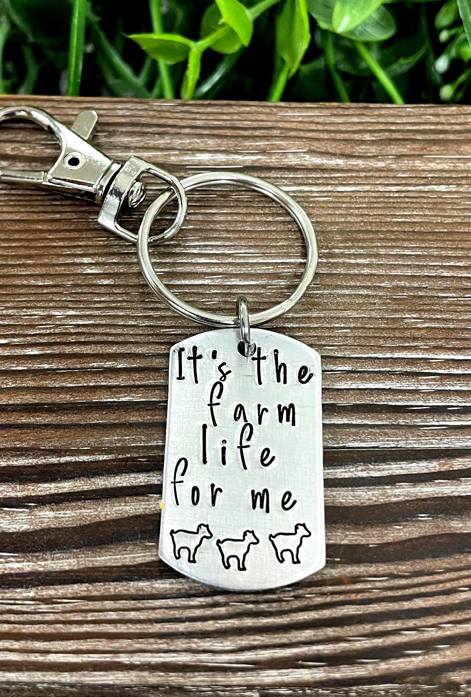 Hand-stamped key chain featuring the phrase 'It’s the farm life for me' with fun animal designs, showcasing unique craftsmanship.