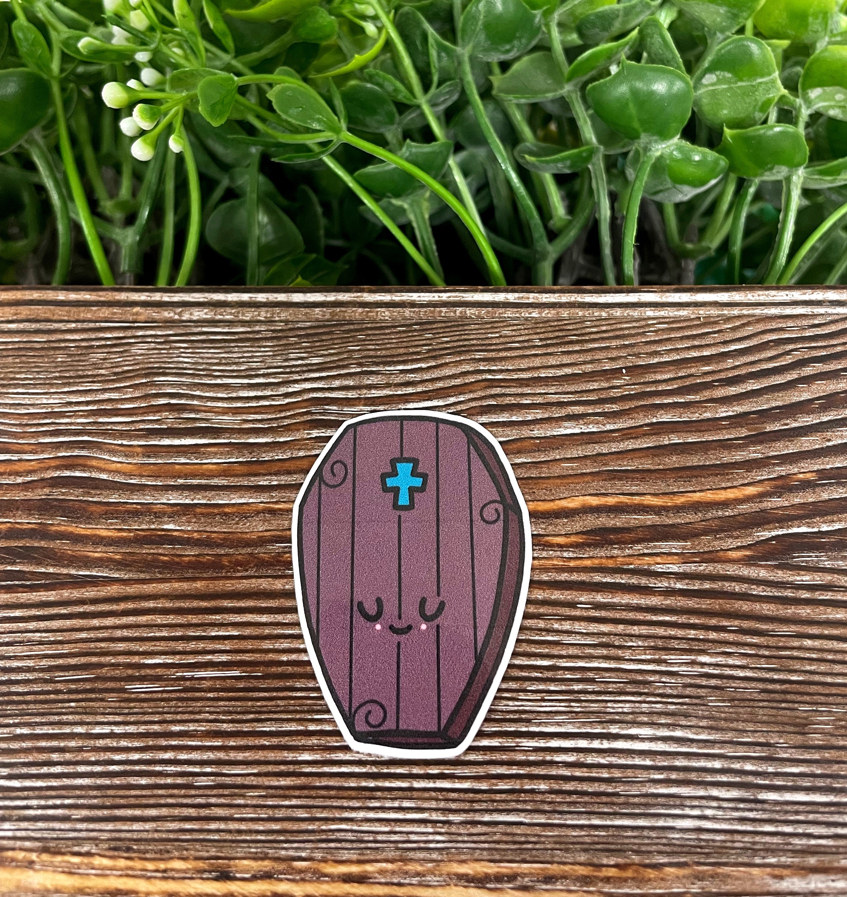 Kawaii Coffin die cut sticker featuring a cute graphic design, perfect for personalizing items like notebooks and water bottles.