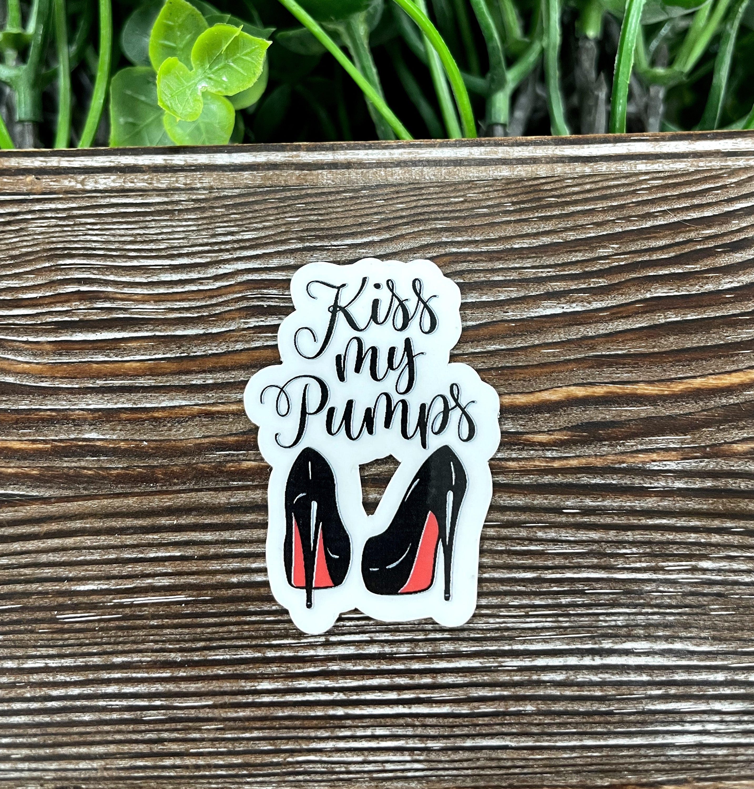 Kiss my Pumps Red Heels Die Cut Sticker on a smooth surface, showcasing vibrant red heels design.
