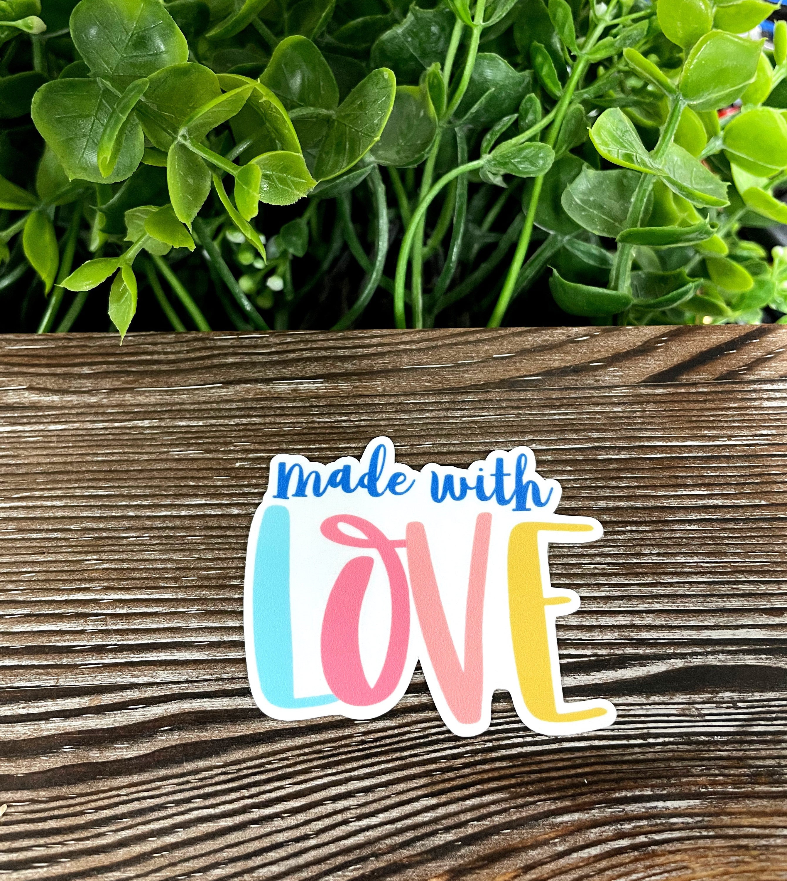 A vibrant Made With Love die cut vinyl sticker featuring boho design elements, perfect for personalizing various smooth surfaces.