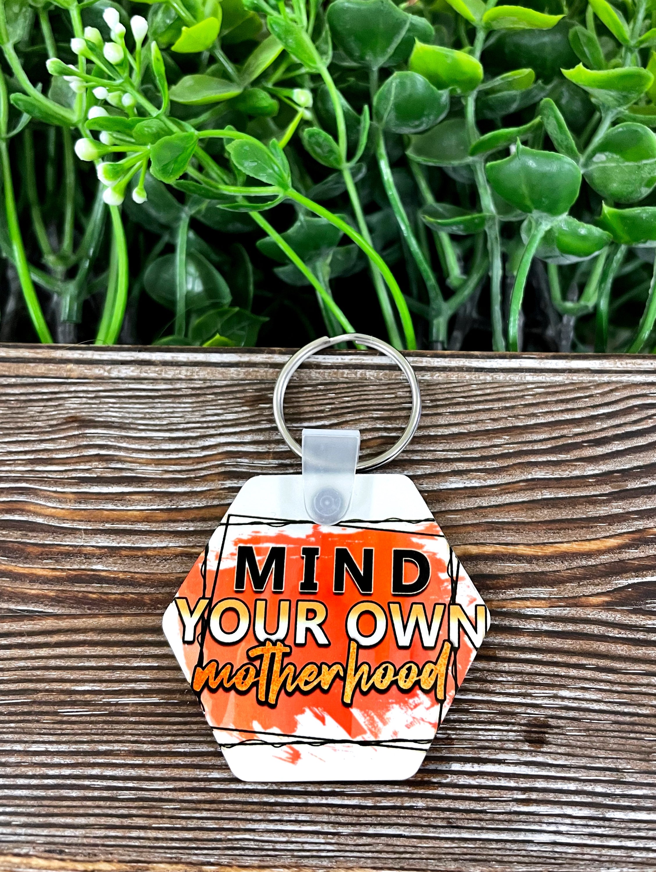 Mind Your Own Motherhood MDF Hexagon Keychain in vibrant colors, lightweight and stylish, perfect for personal expression.
