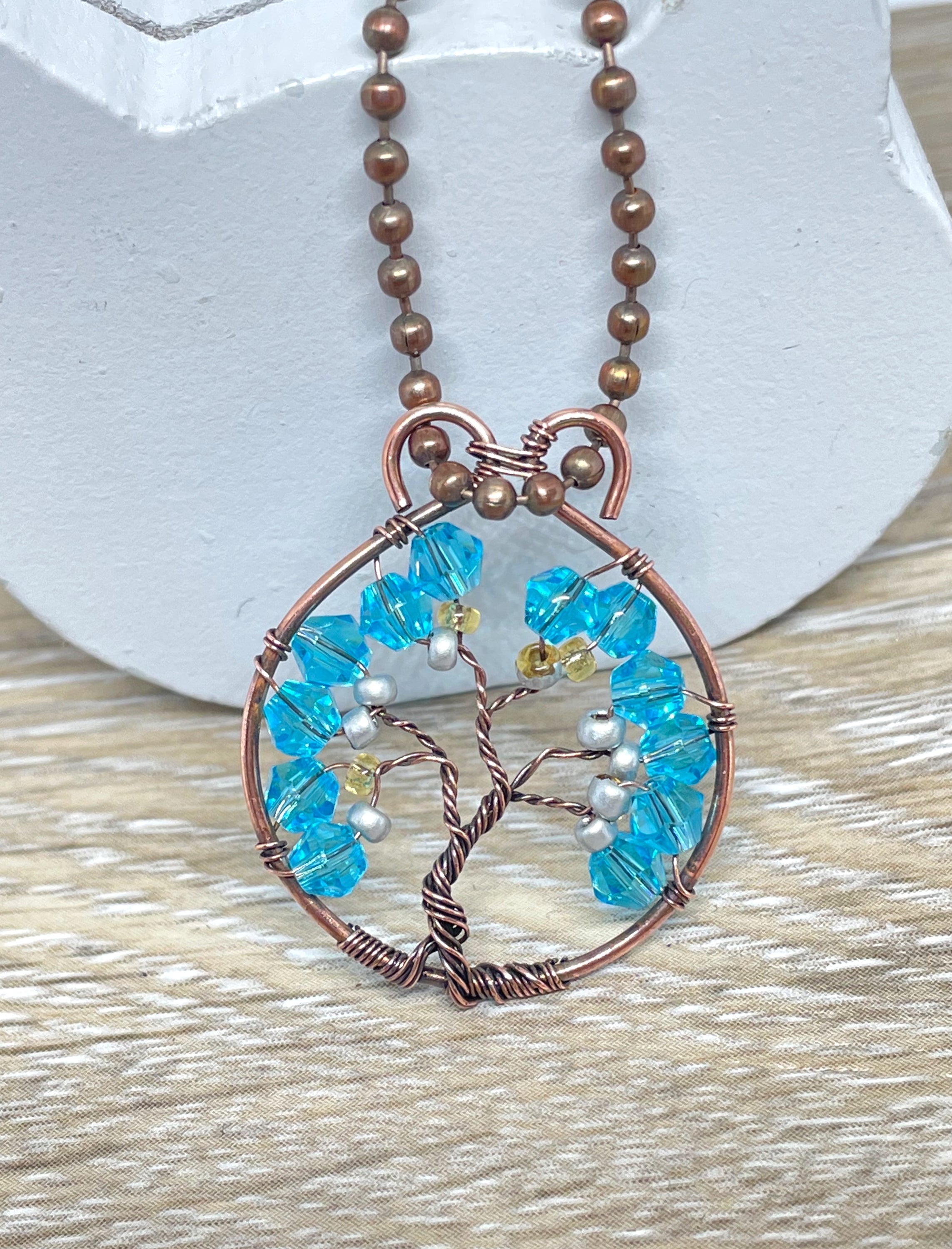 Mini Wire Wrapped Tree of Life Pendant featuring gemstone chips wrapped in oxidized copper wire on an 18-inch ball chain.