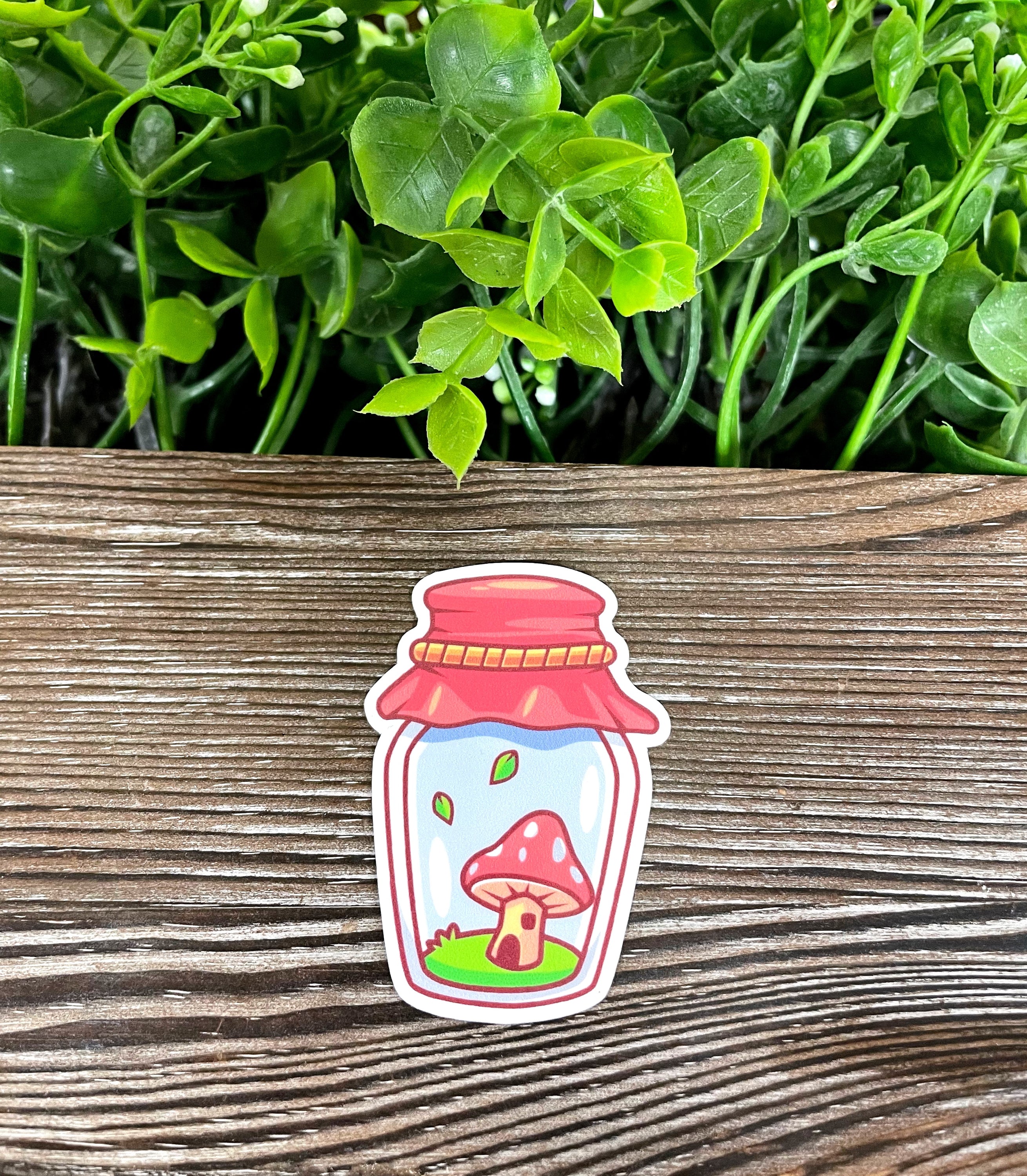 A vibrant die cut vinyl sticker featuring a whimsical mushroom in a mason jar, showcasing boho style and water-resistant quality.