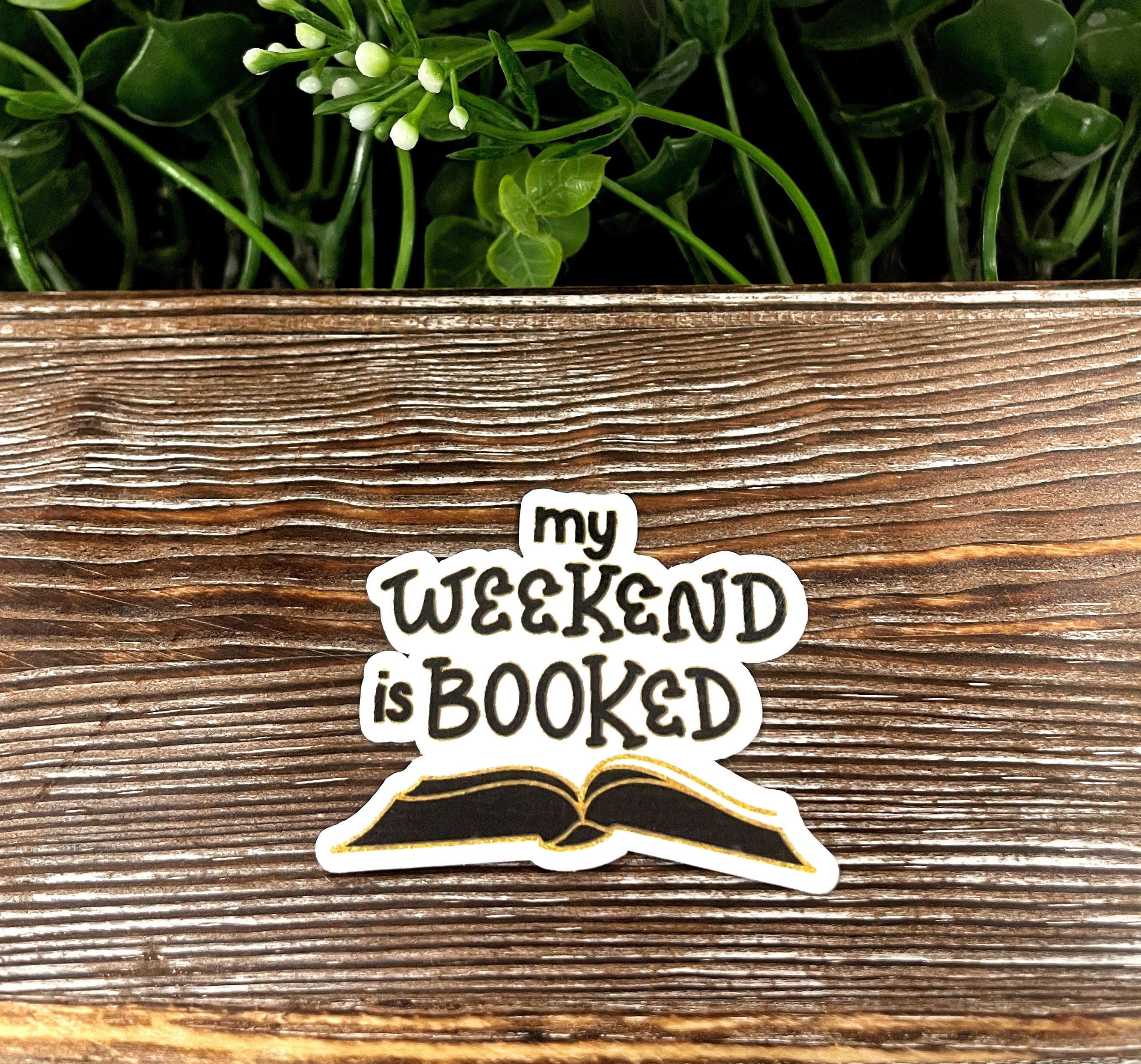 Vinyl decal sticker featuring the phrase 'My Weekend is Booked' with a book design, ideal for personalizing items.