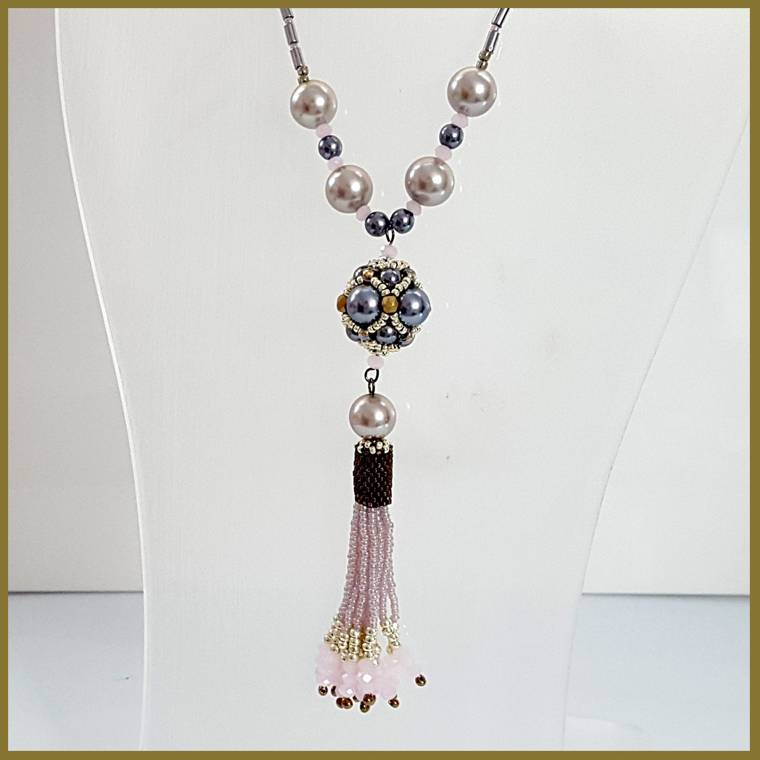 A stunning pink beaded tassel necklace featuring Haematite tubes, handmade with Toho and Delica beads, showcasing a boho chic design.