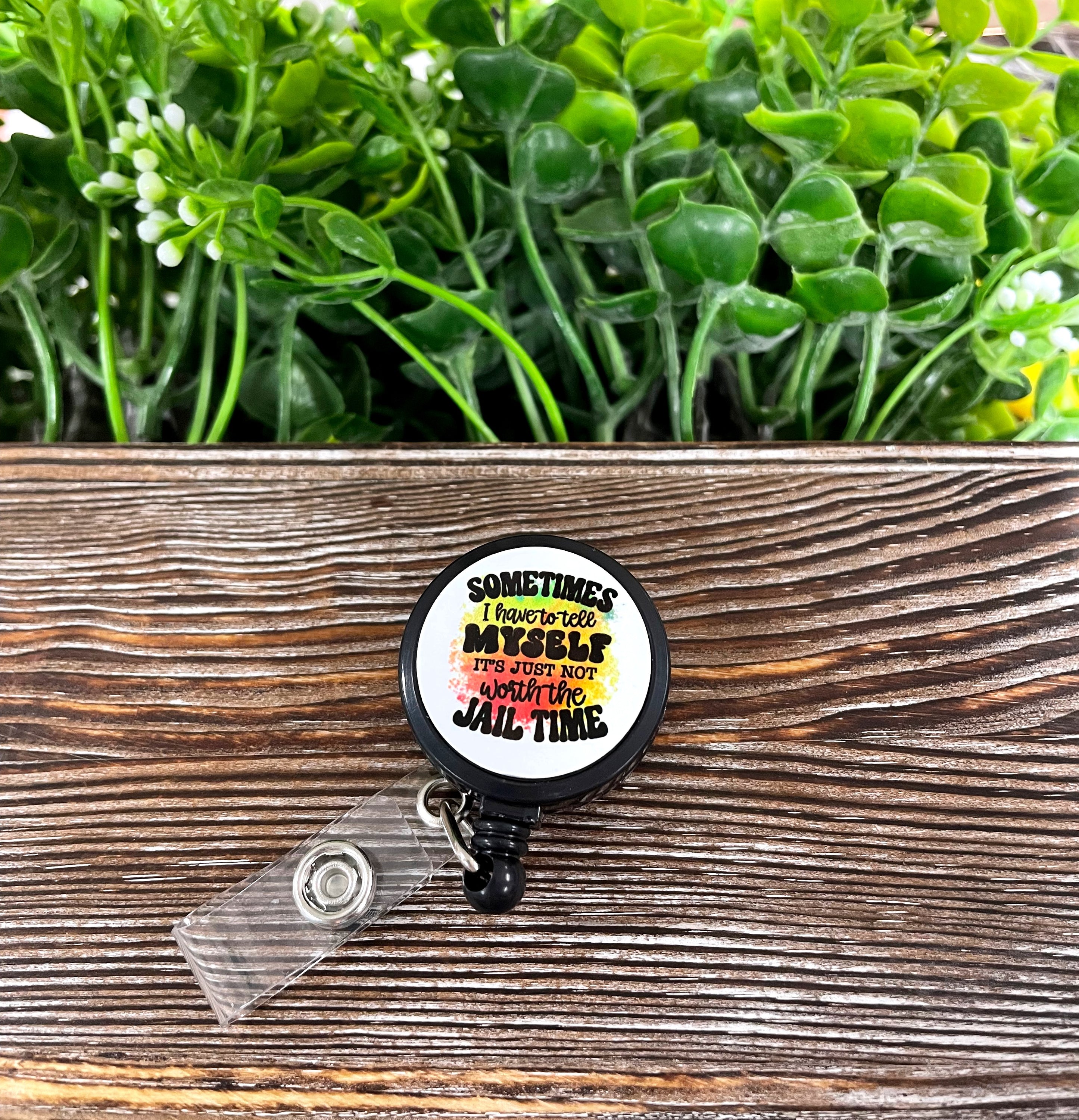 Not Worth the Jail Time retractable badge reel featuring a boho design on a metal blank attached to a plastic reel.