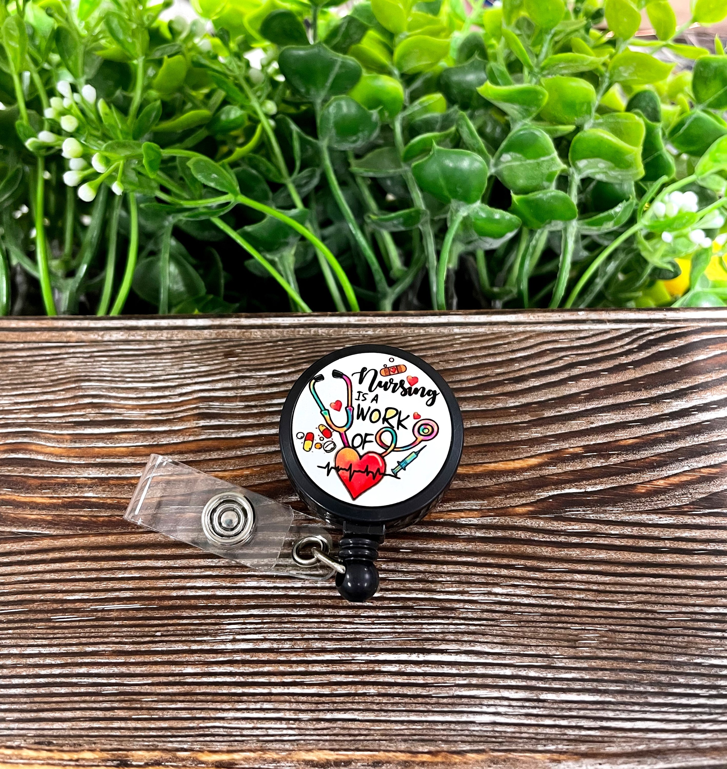 Nursing is a Work of Heart retractable badge reel featuring a colorful boho design, perfect for healthcare professionals.