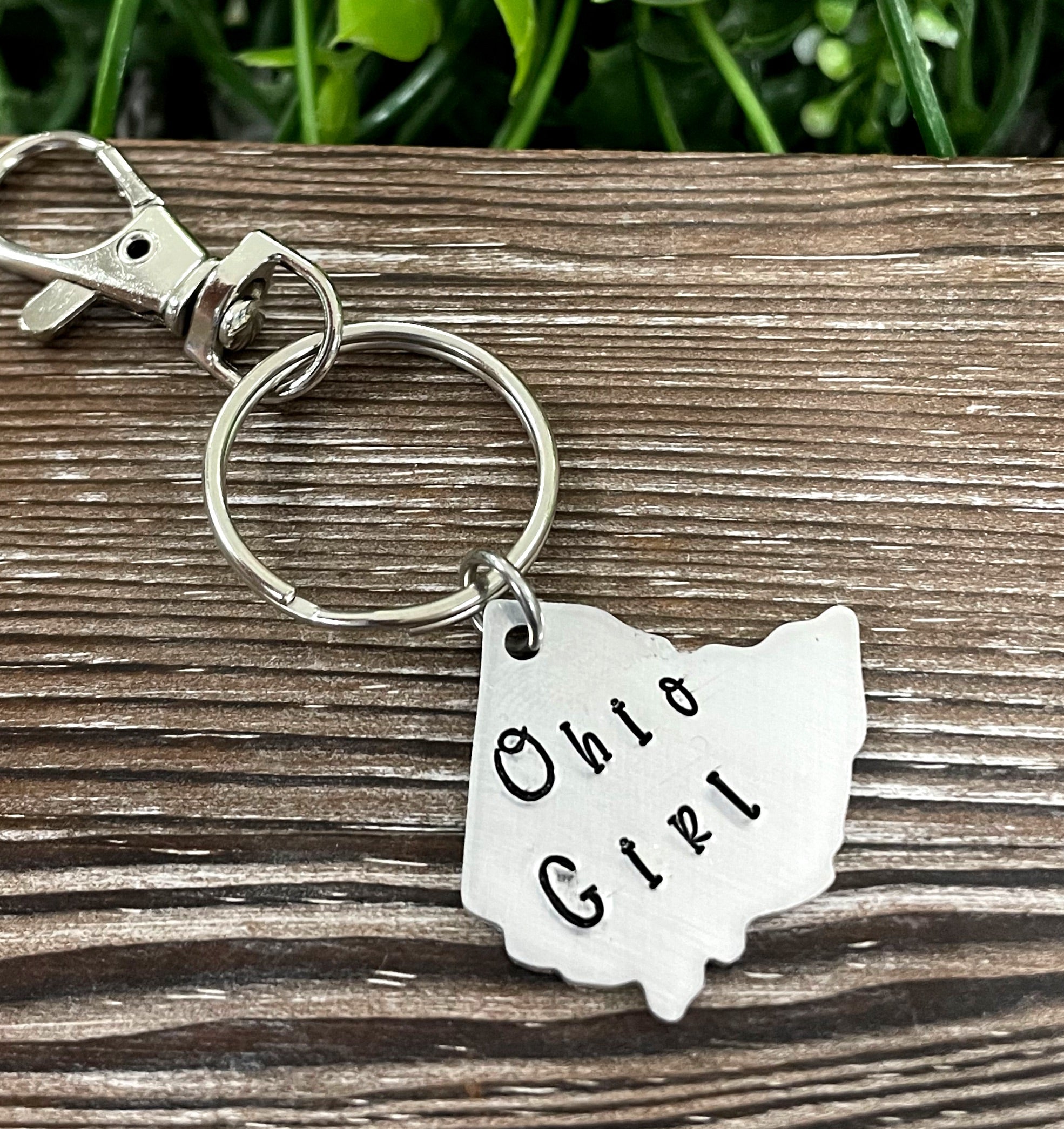 Hand-stamped keychain featuring the phrase 'Ohio Girl', showcasing unique lettering and design.