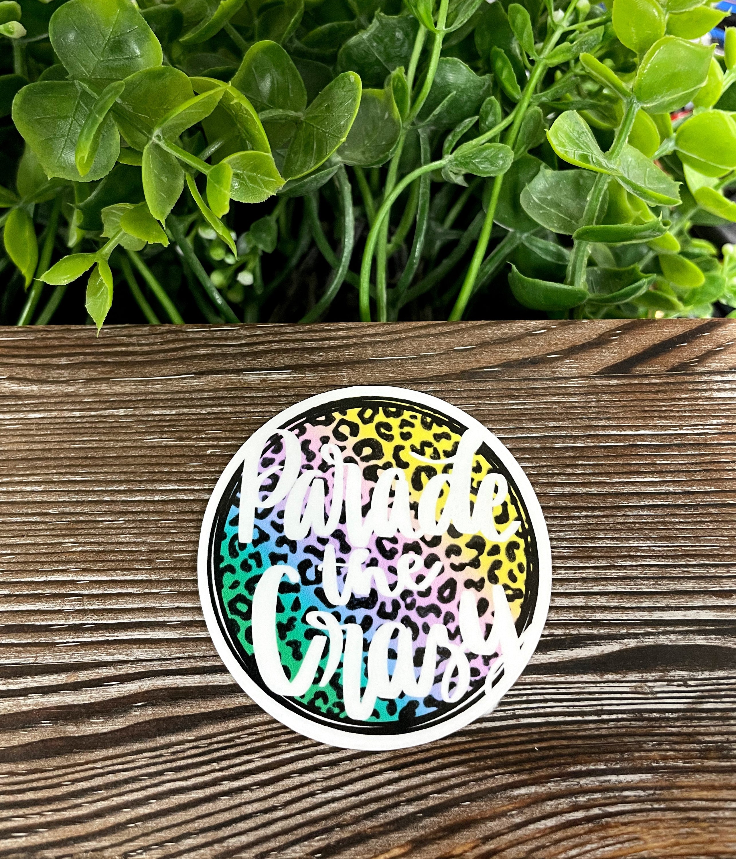 Colorful Parade the Crazy die cut vinyl sticker on a smooth surface, showcasing boho design and water-resistant features.