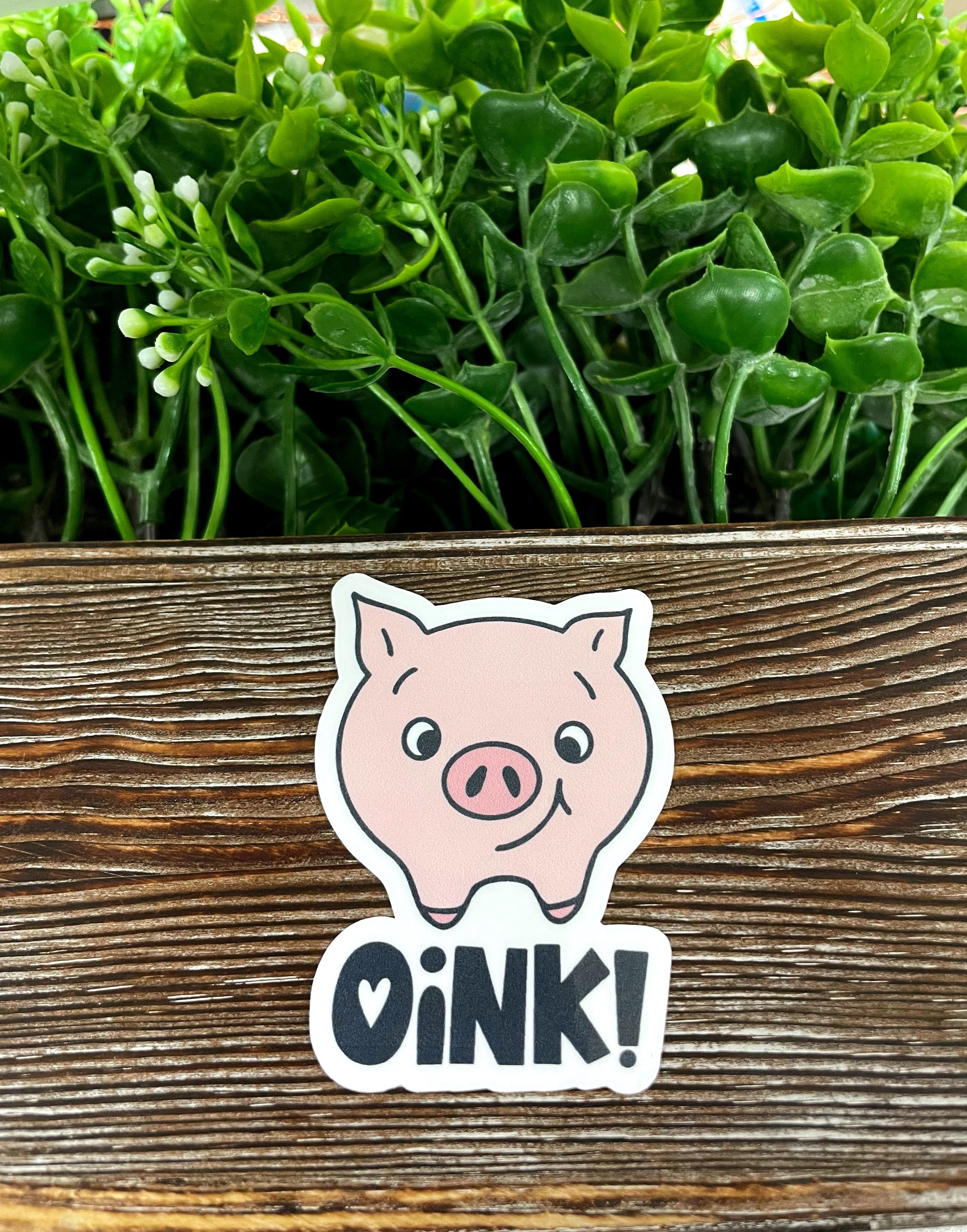 A vibrant pink pig die cut vinyl sticker with a playful design, showcasing its water-resistant feature and ideal for smooth surfaces.