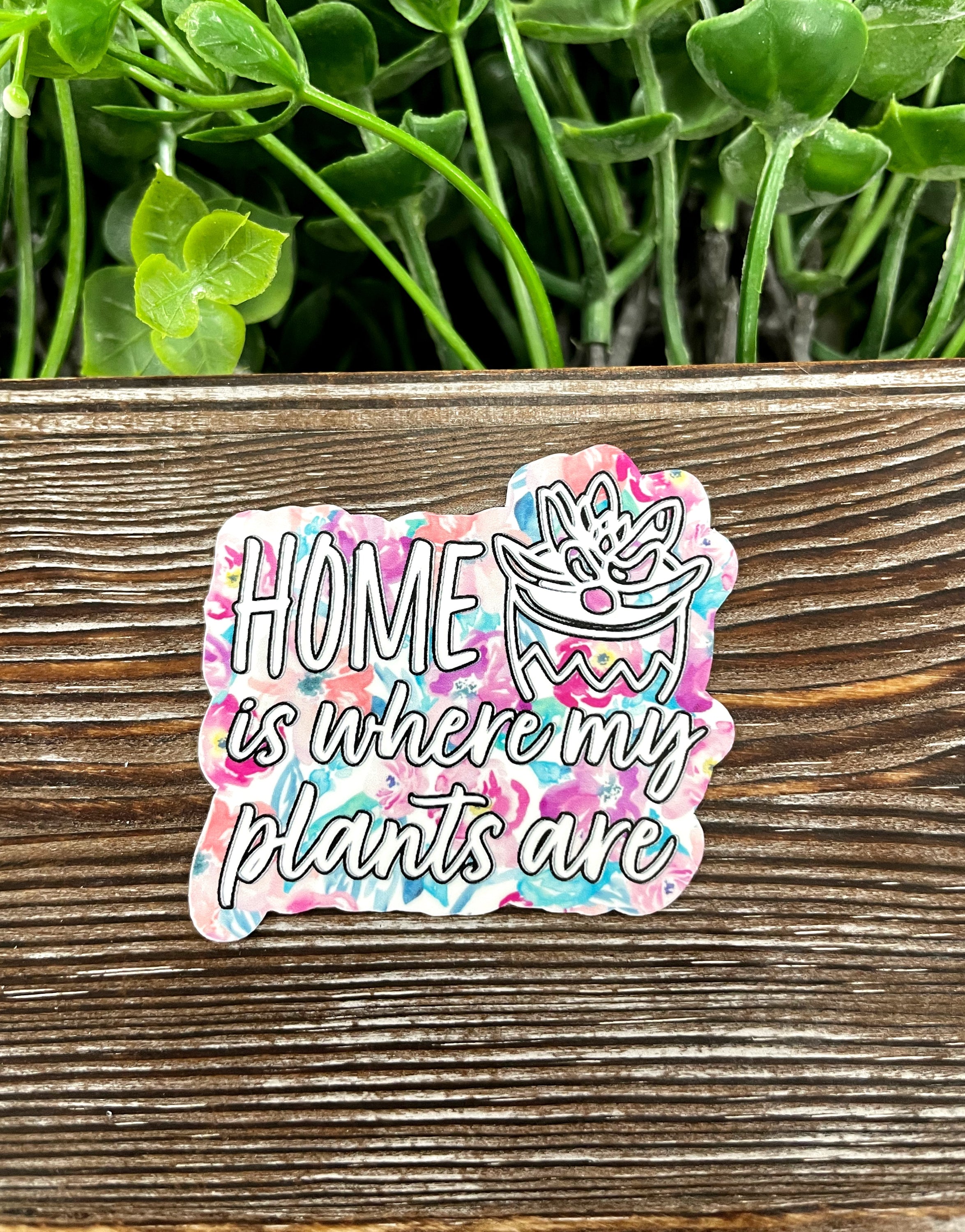 Die cut sticker featuring the phrase 'Home is Where my Plants Are', designed for plant lovers, showcasing vibrant colors and a stylish graphic art design.