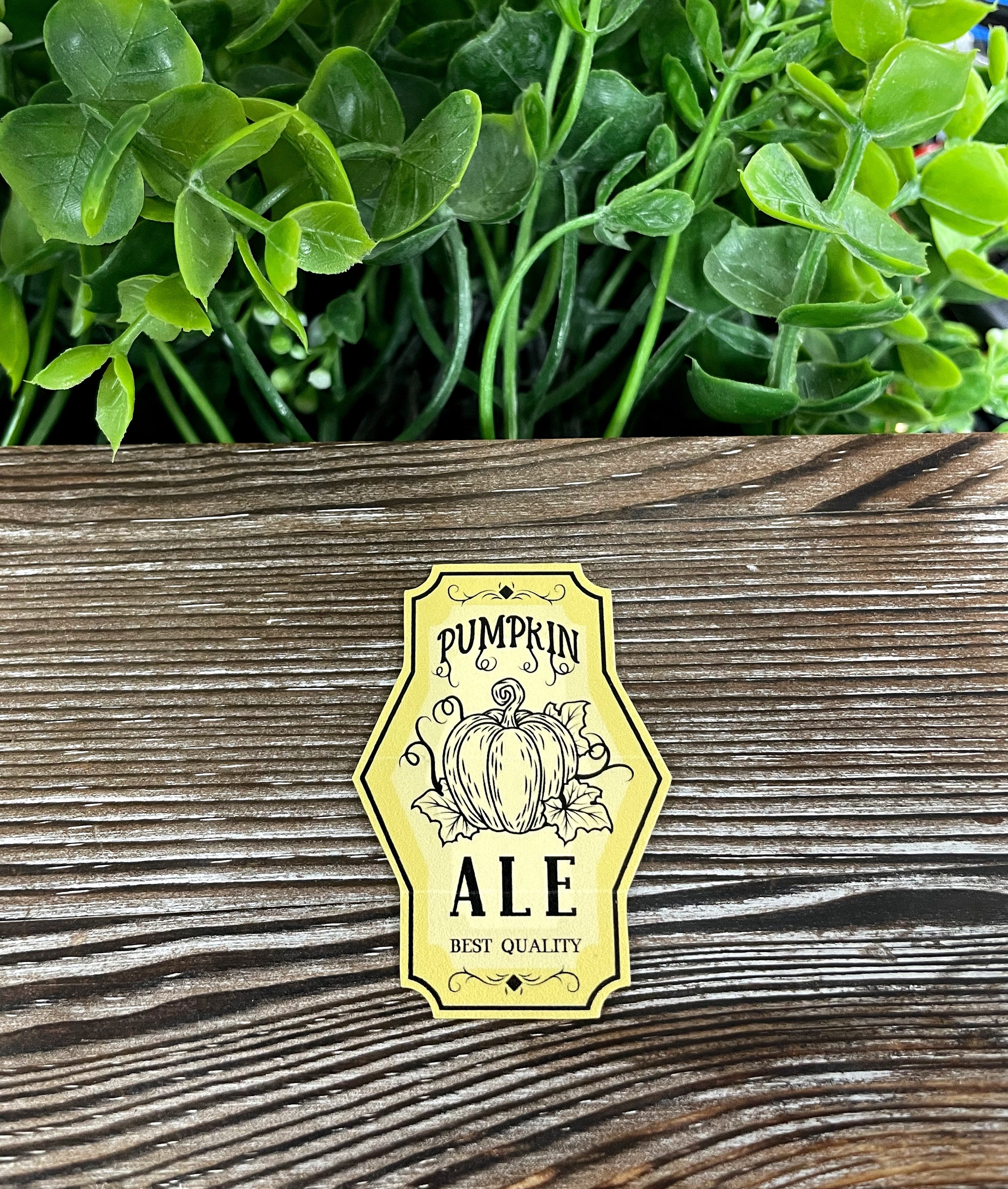 Colorful Pumpkin Ale die cut vinyl sticker on a smooth surface, showcasing its vibrant design and water-resistant laminate.