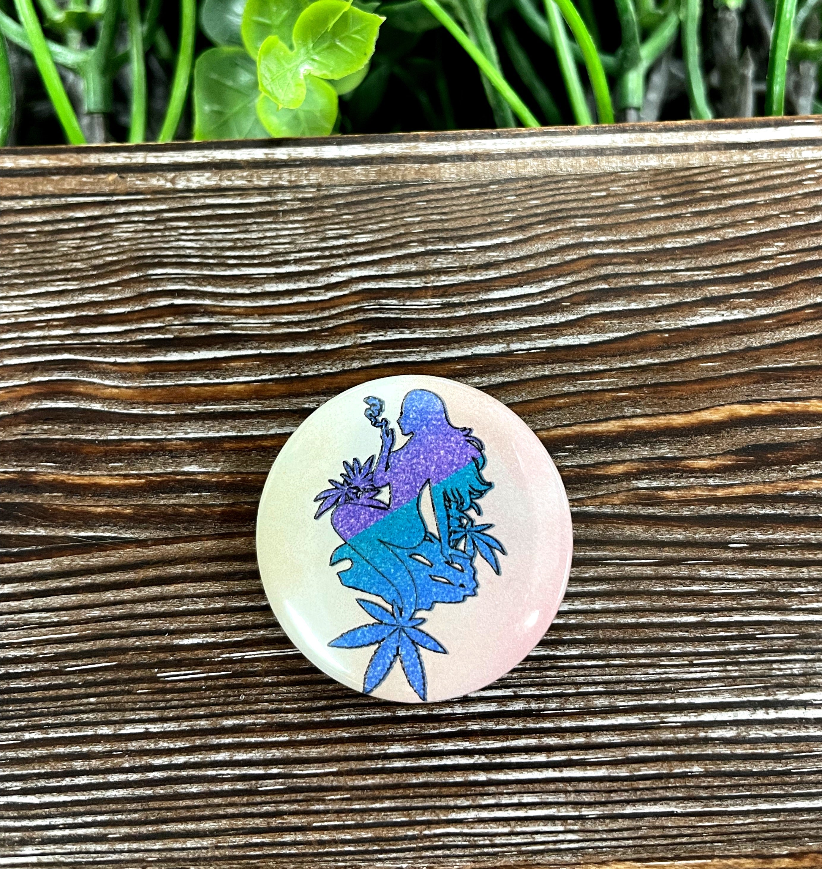 Purple and blue mermaid graphic art button, 1.25 inches, featuring vibrant colors and a whimsical design.